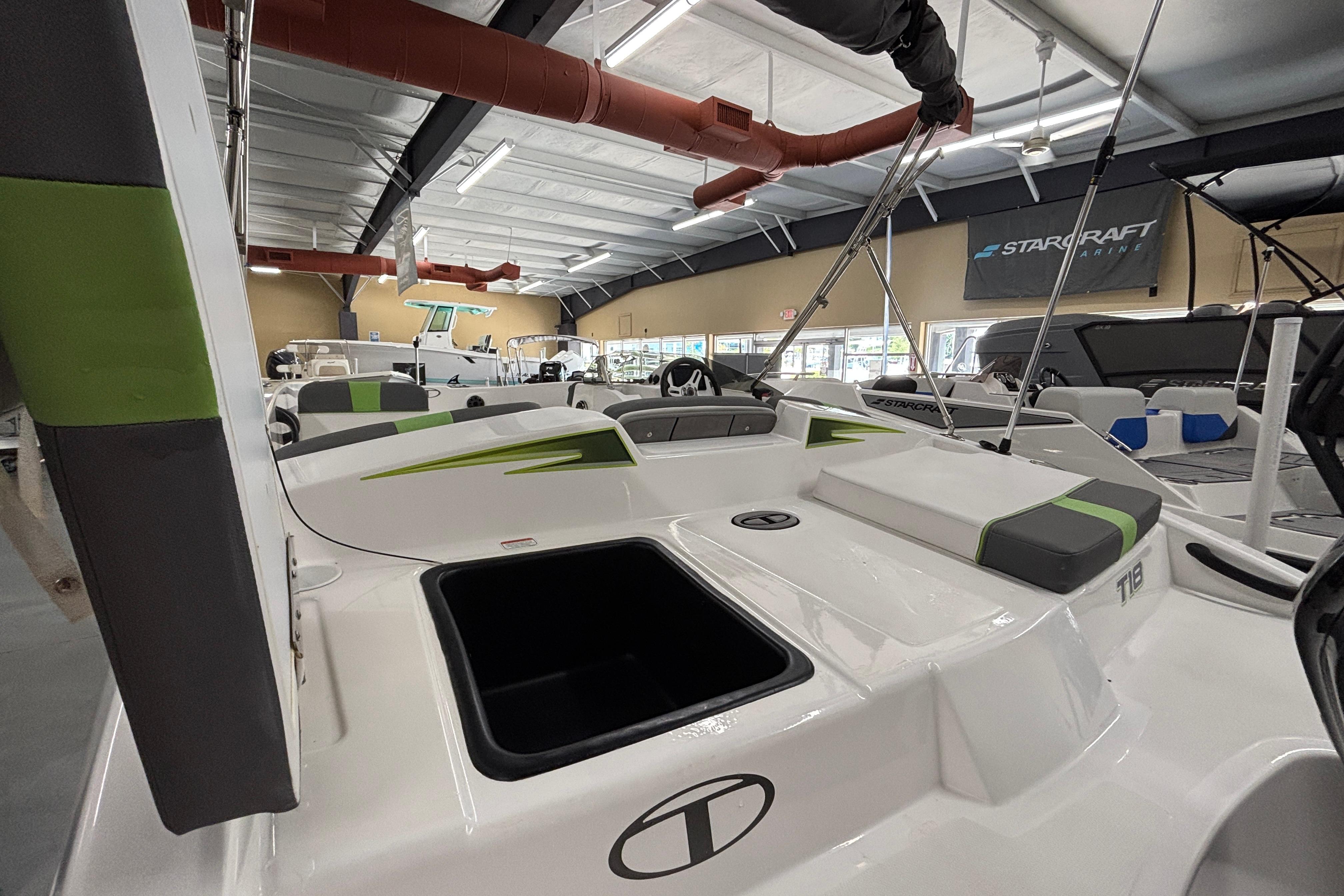 2024 Tahoe T18 boat interior in showroom, featuring sleek design and modern seating.