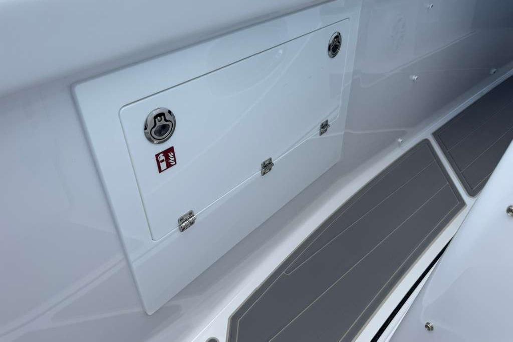 2026 Monterey Elite 30 OB boat storage compartment with fire extinguisher symbol.