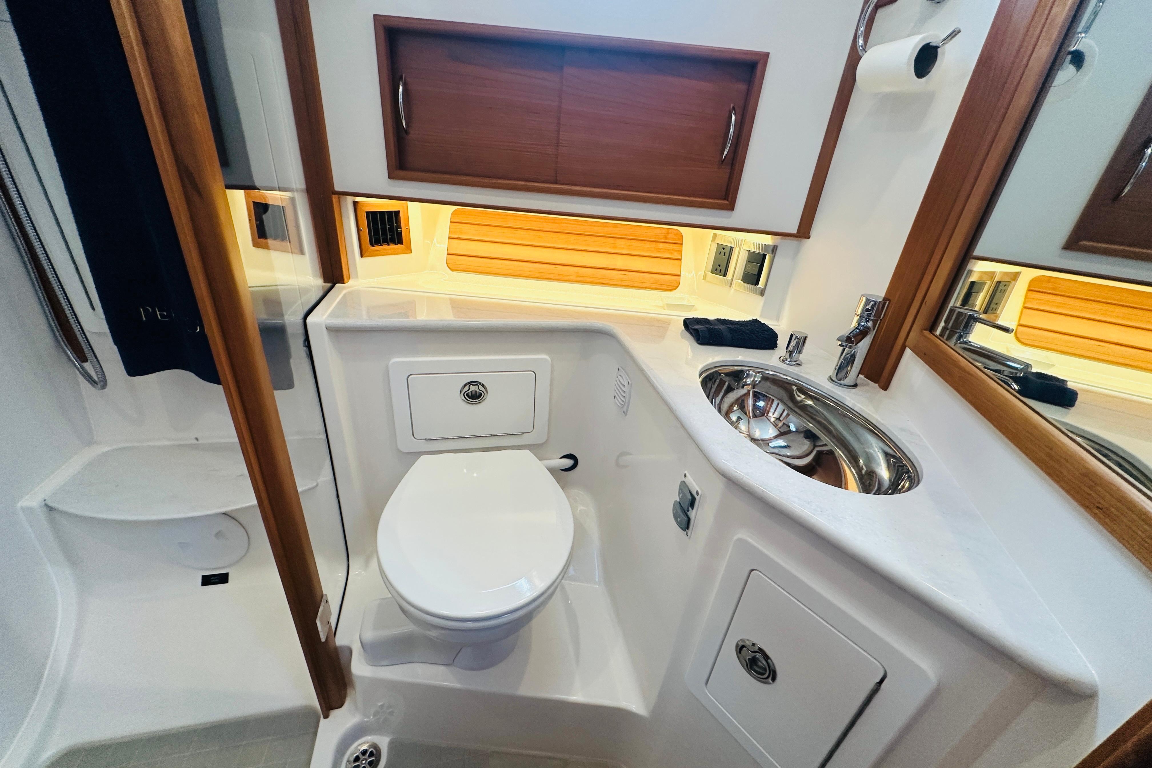 2025 Sabre 48 Salon Express bathroom with modern fixtures and wooden accents.