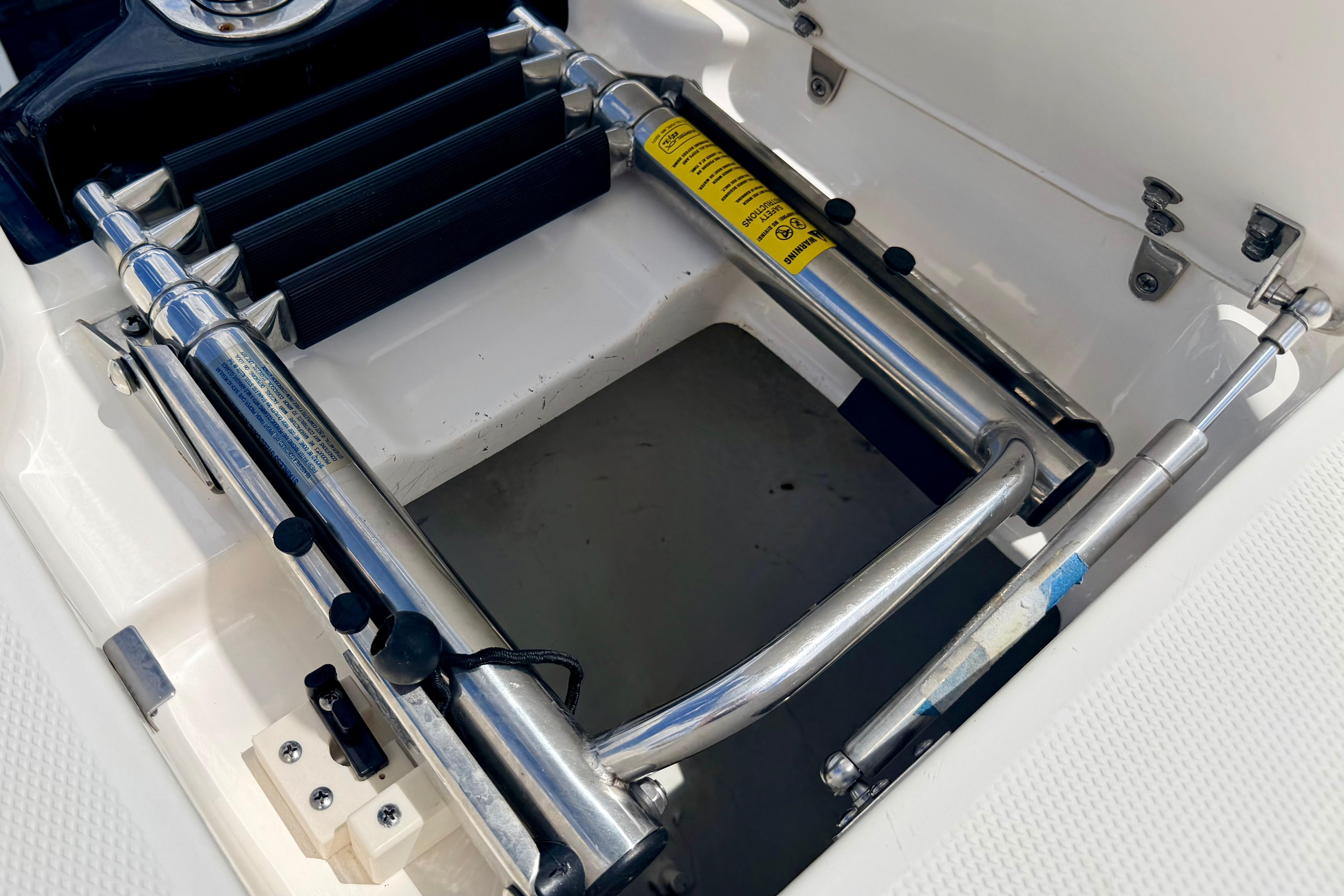 Stainless steel ladder on 2015 Chaparral Sunesta 264 boat, folded and secured.