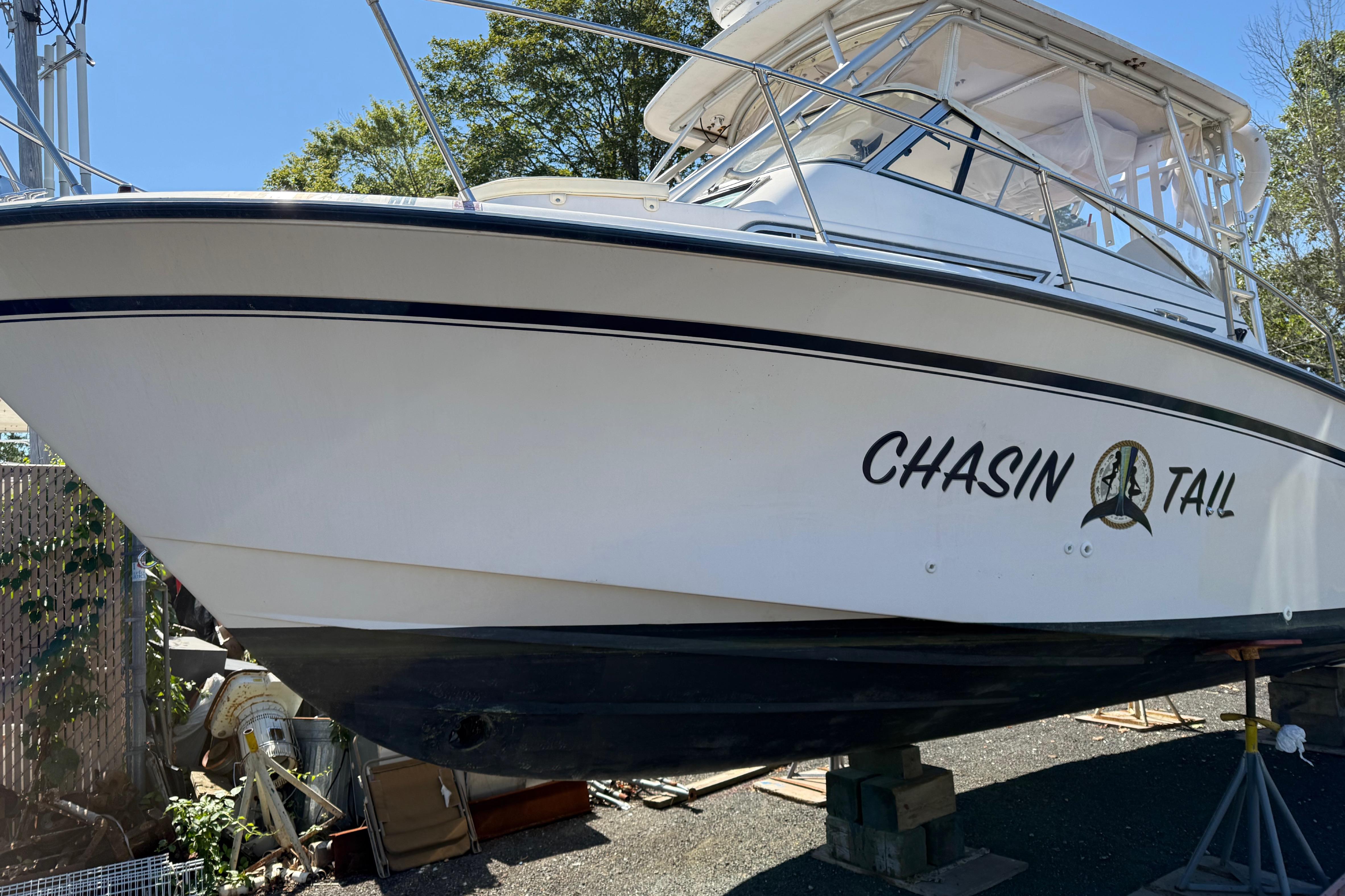 1996 Grady-White Marlin 300 boat named "Chasin Tail" on dry dock.