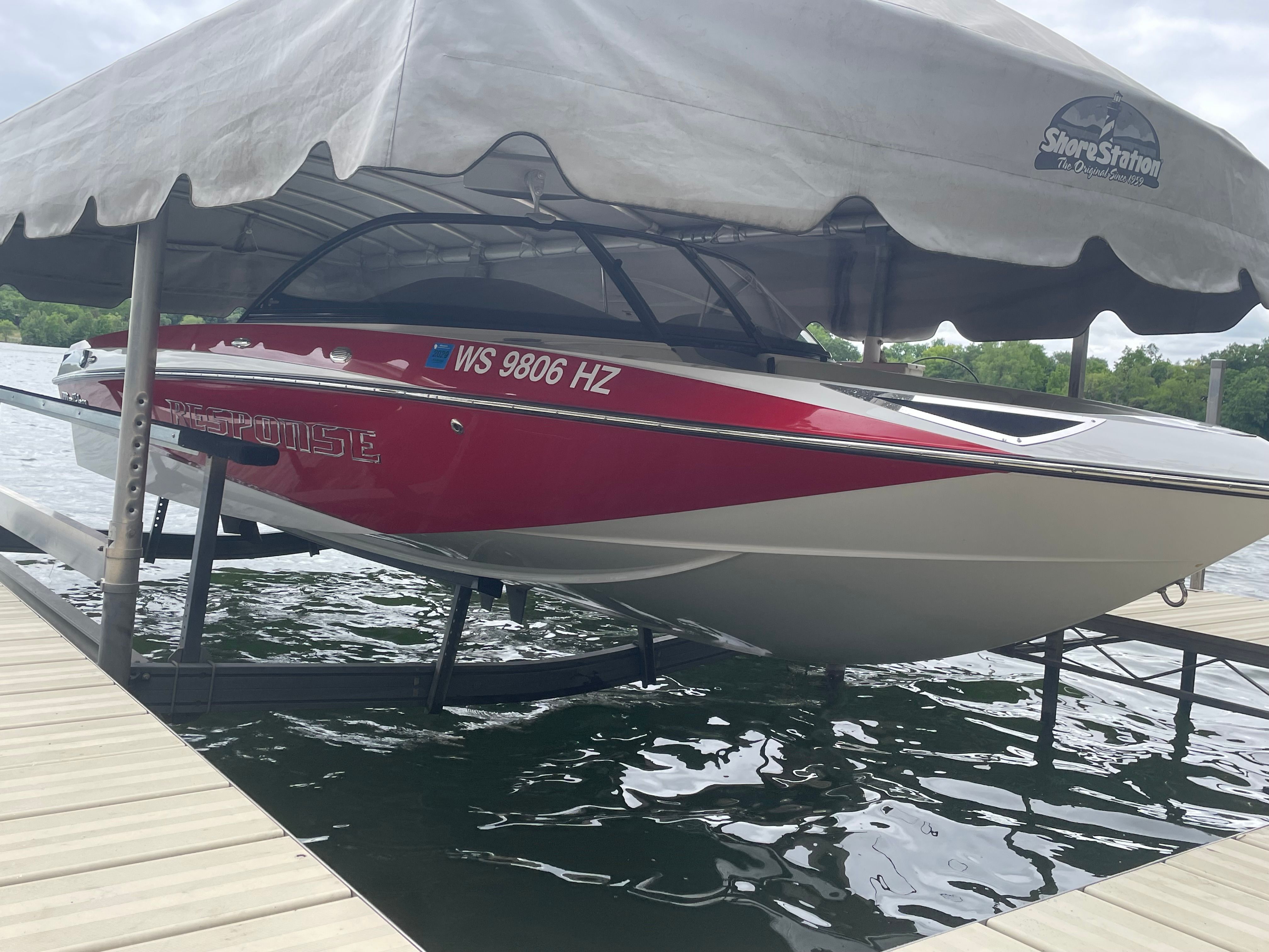 2014 Malibu Response TXi boat on a lift at the dock.