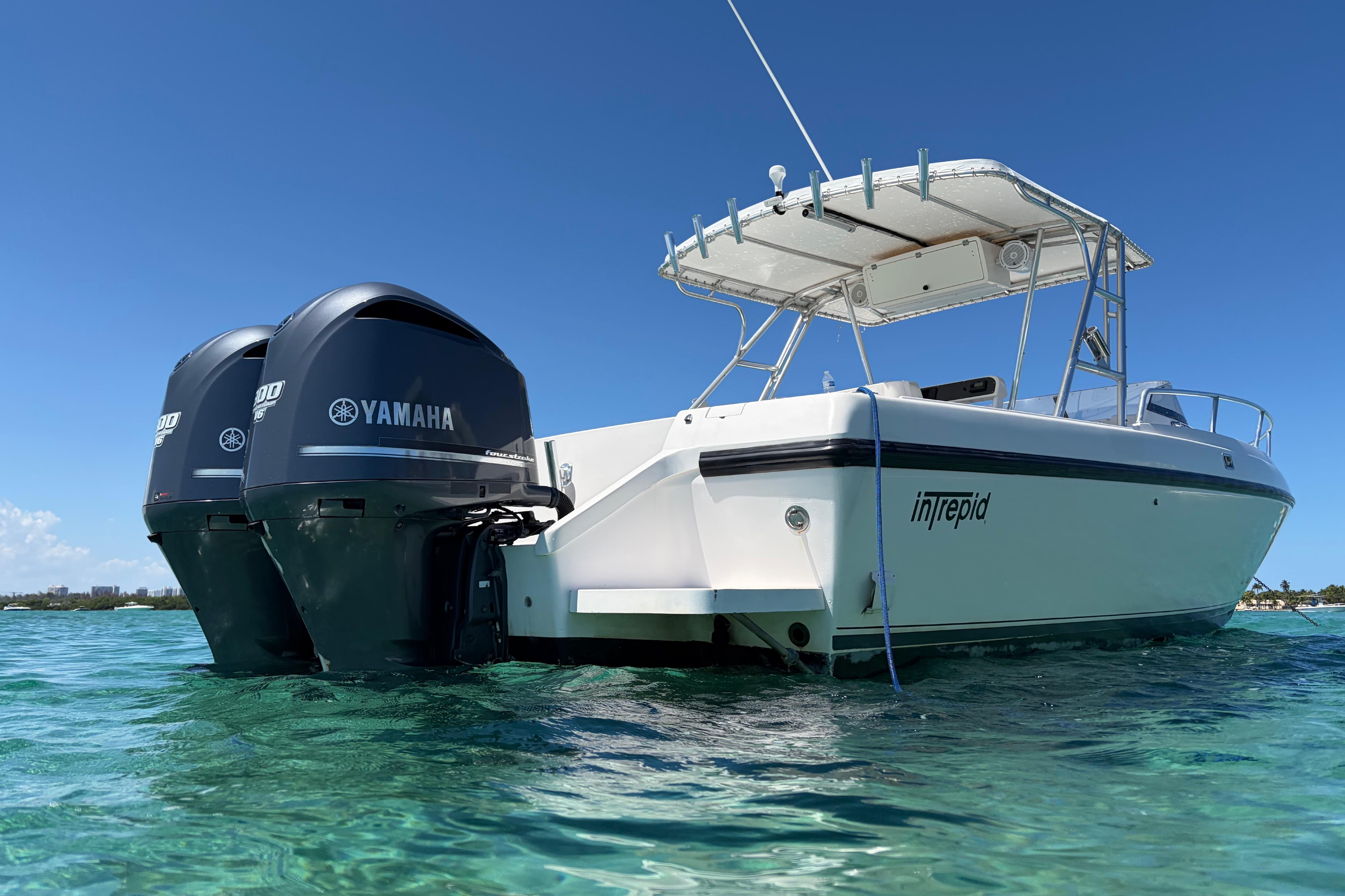 1998 Intrepid 339 Walkaround boat with Yamaha engines on clear blue water.