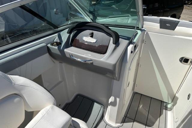2023 Chaparral 23 SSi boat interior with steering wheel and seating area.