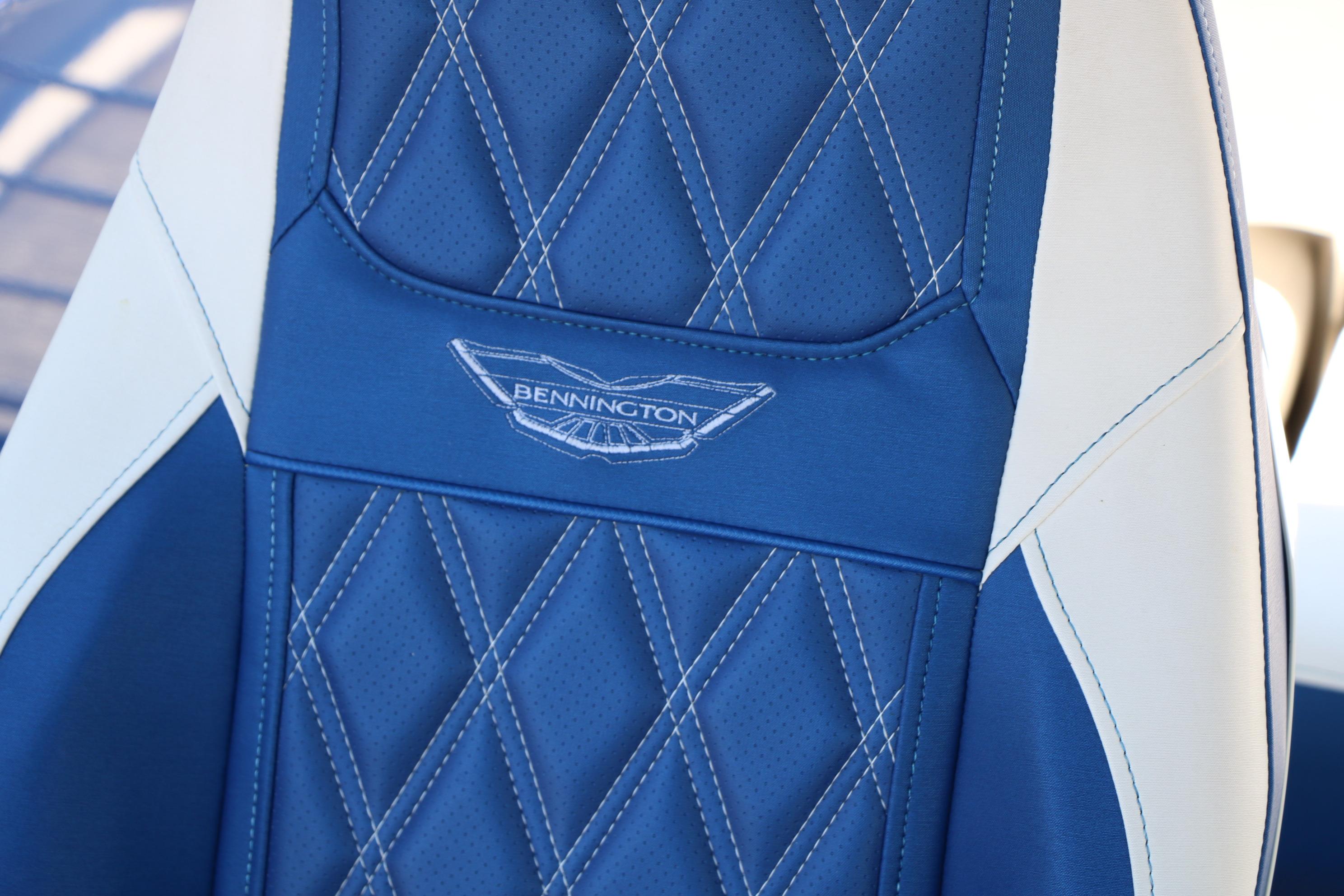 Blue and white seat detail of 2024 Bennington 23 RX Swingback boat with logo.