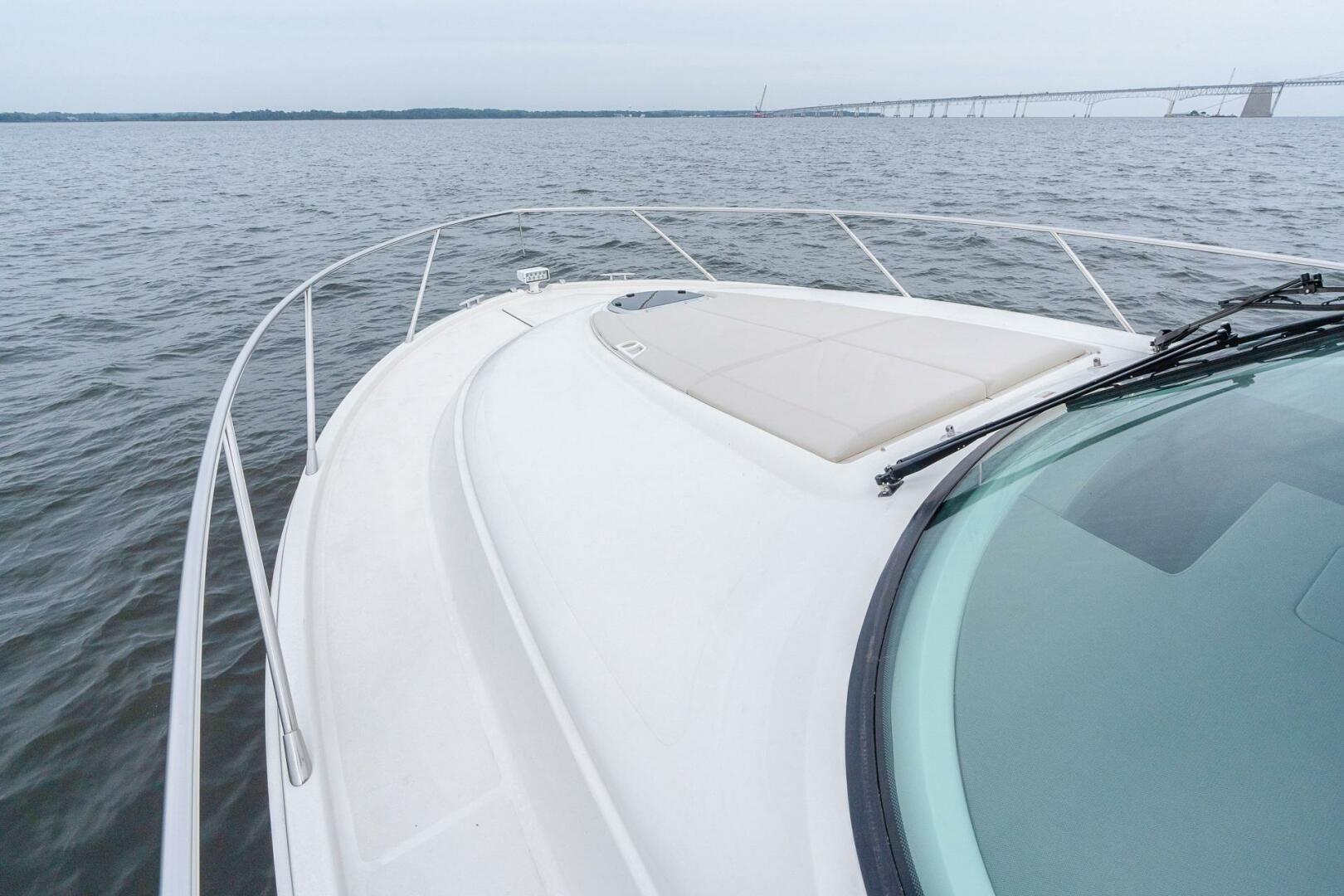 2021 Tiara Yachts F44 Flybridge on open water with bridge in background.