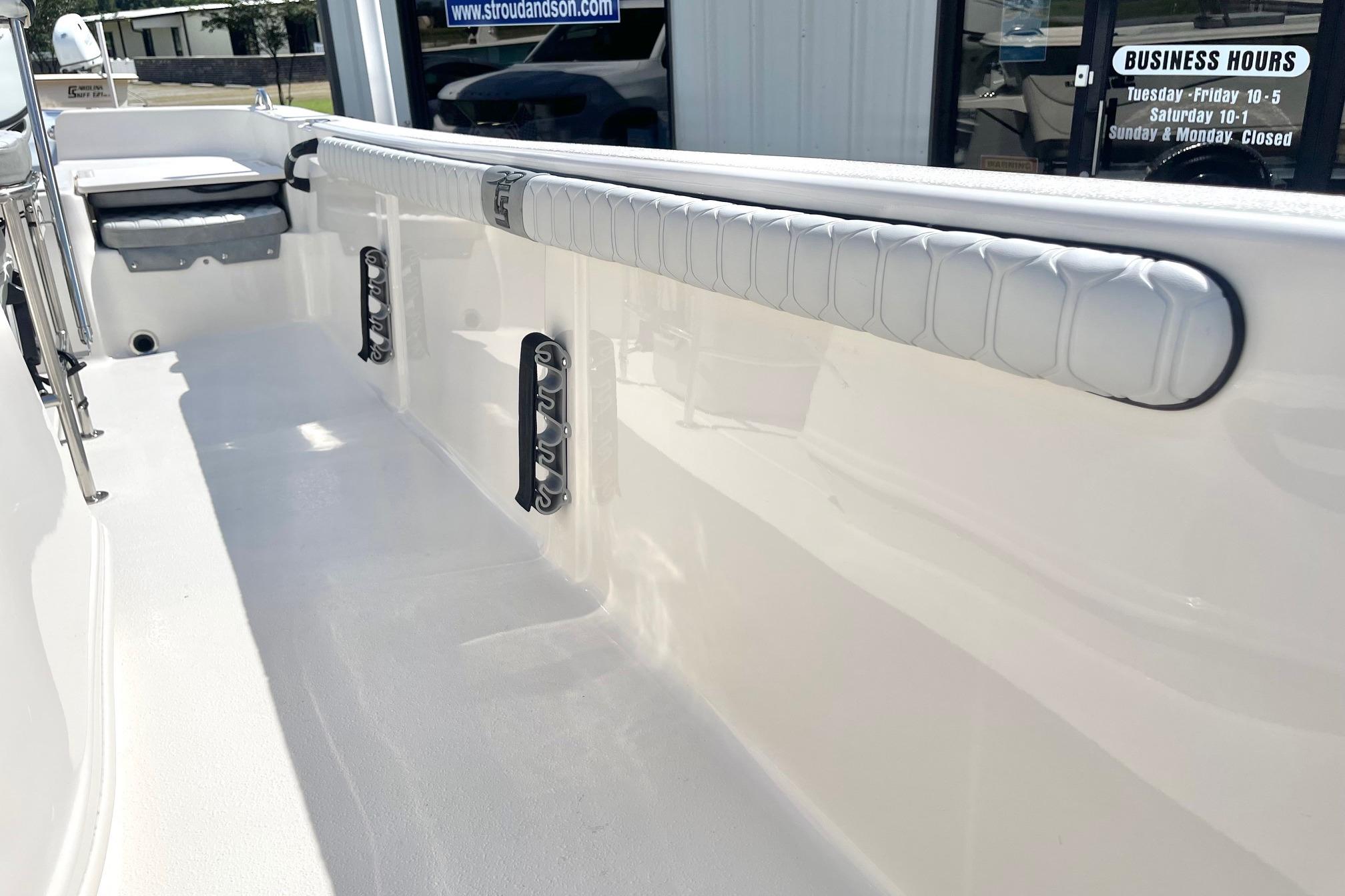 2026 Carolina Skiff 19 LS boat interior with padded side rail and storage compartments.