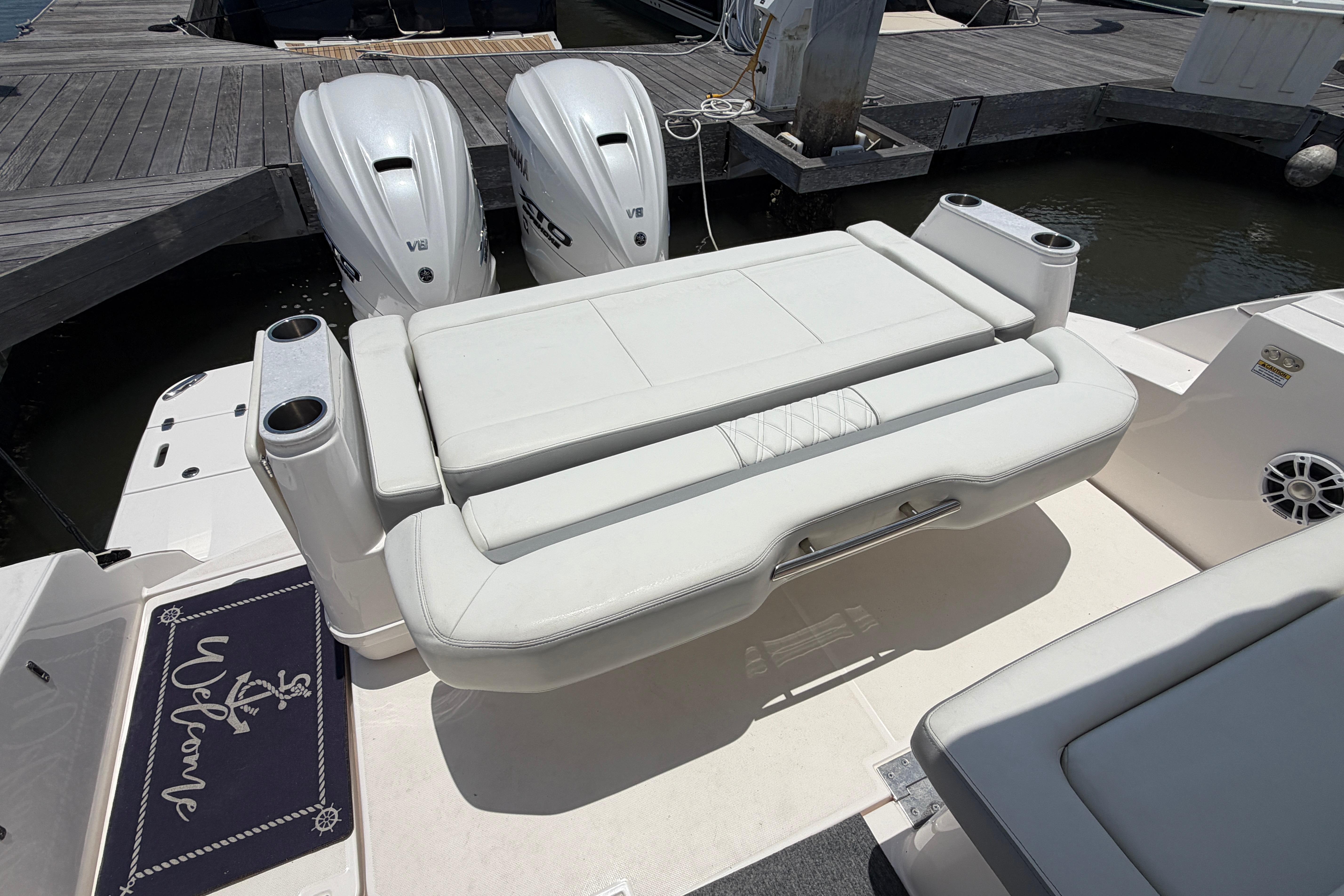2024 Regal 36 XO boat with twin engines and cushioned seating at the dock.