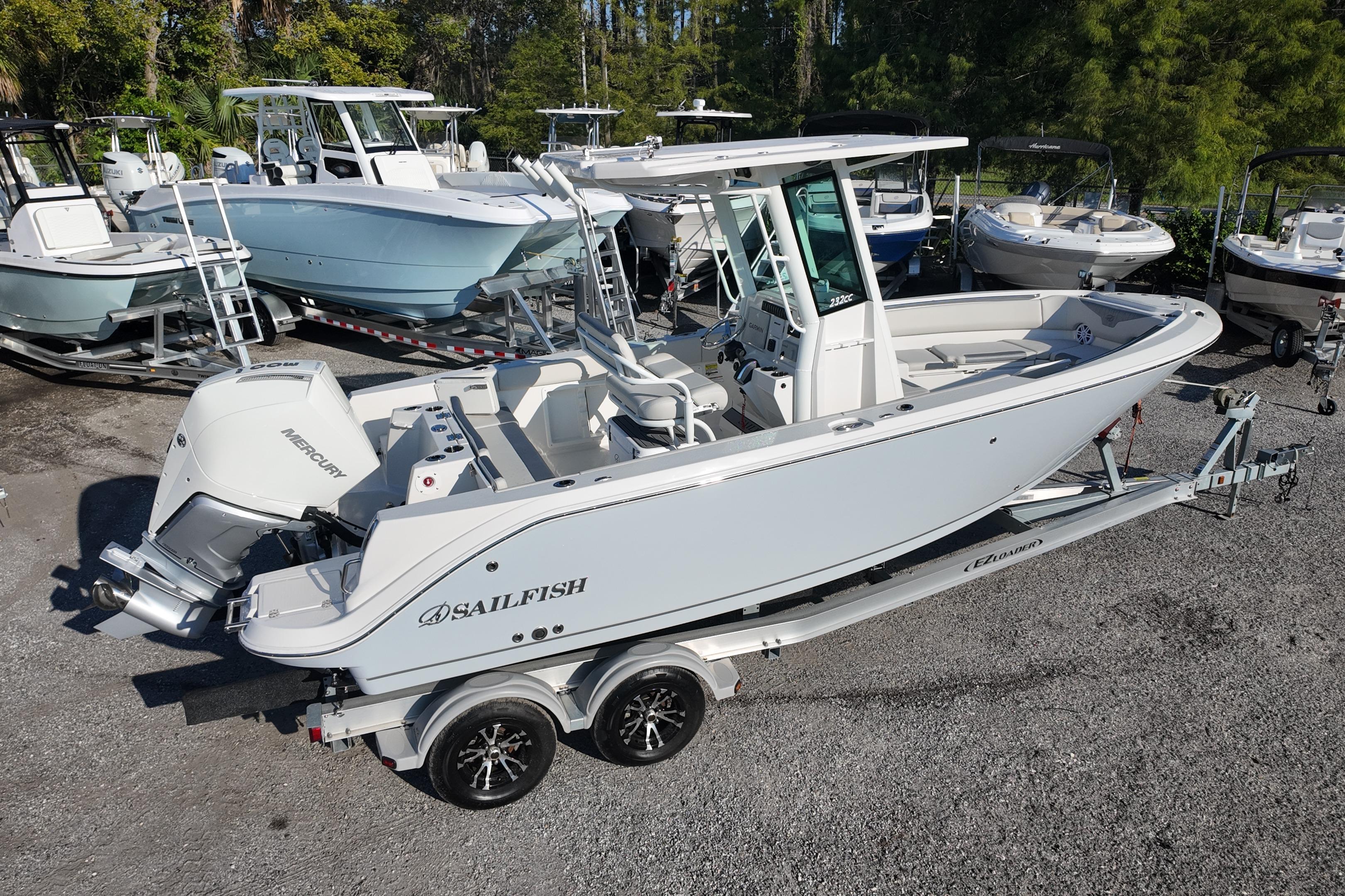 2026 Sailfish 232 CC boat on trailer, surrounded by other boats in a marina.