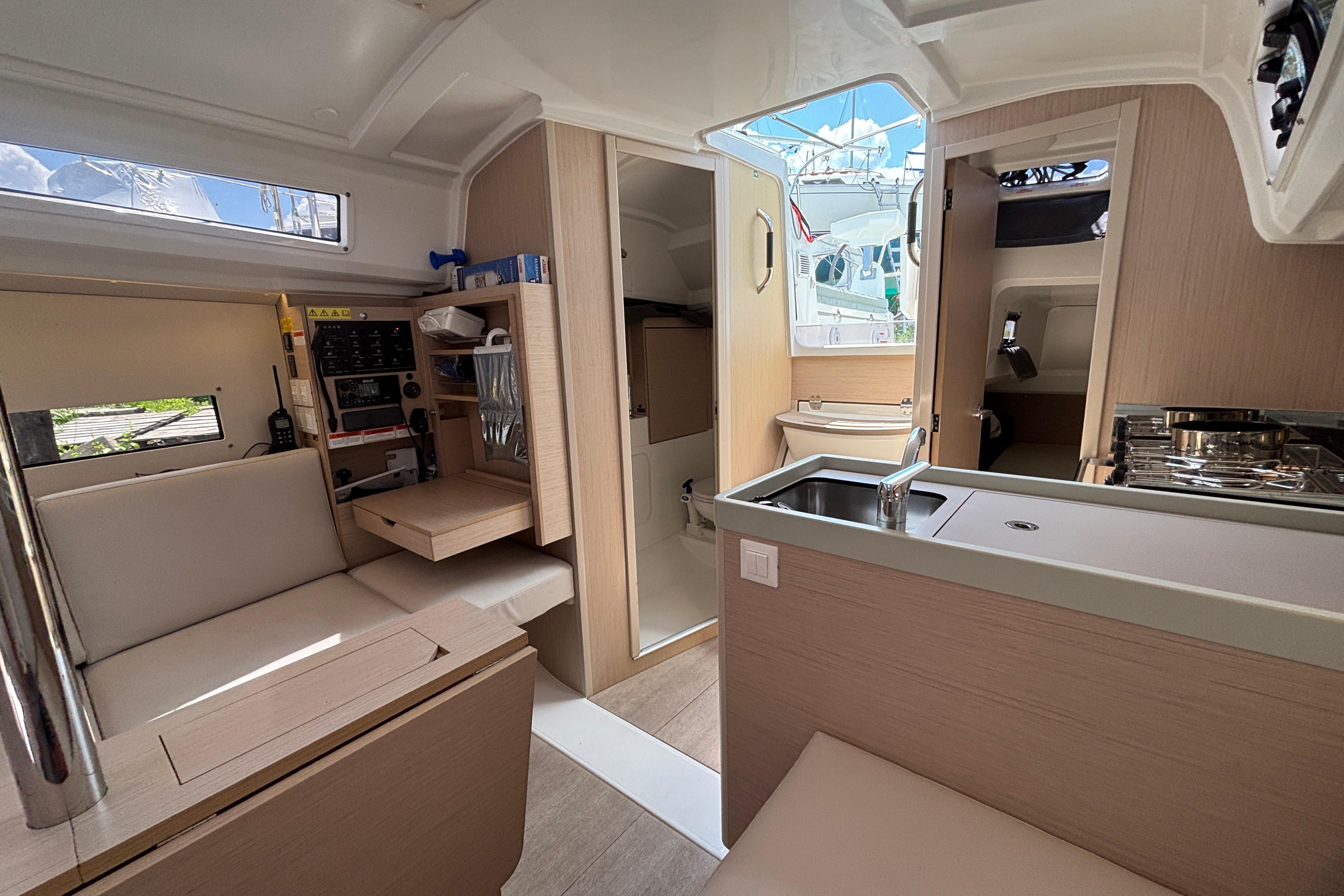 Interior of 2021 Beneteau Oceanis 30.1 yacht, featuring modern kitchen and seating area.