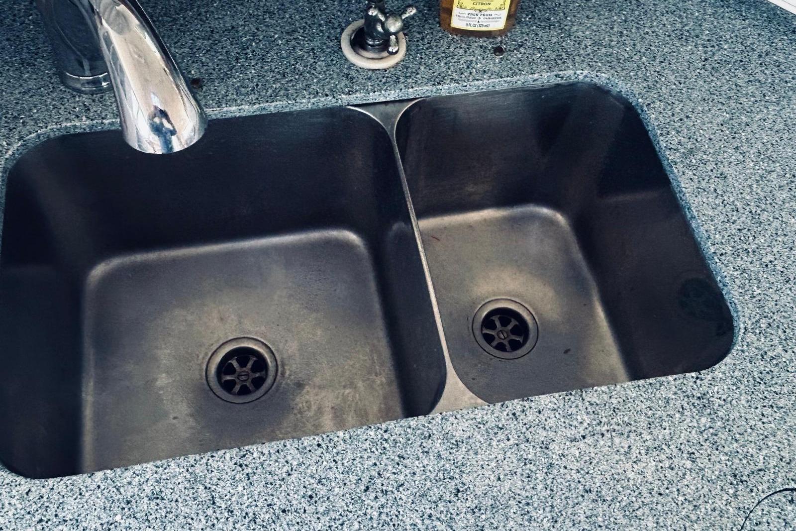 Double kitchen sink with granite countertop on a 2001 Robertson & Caine Leopard.