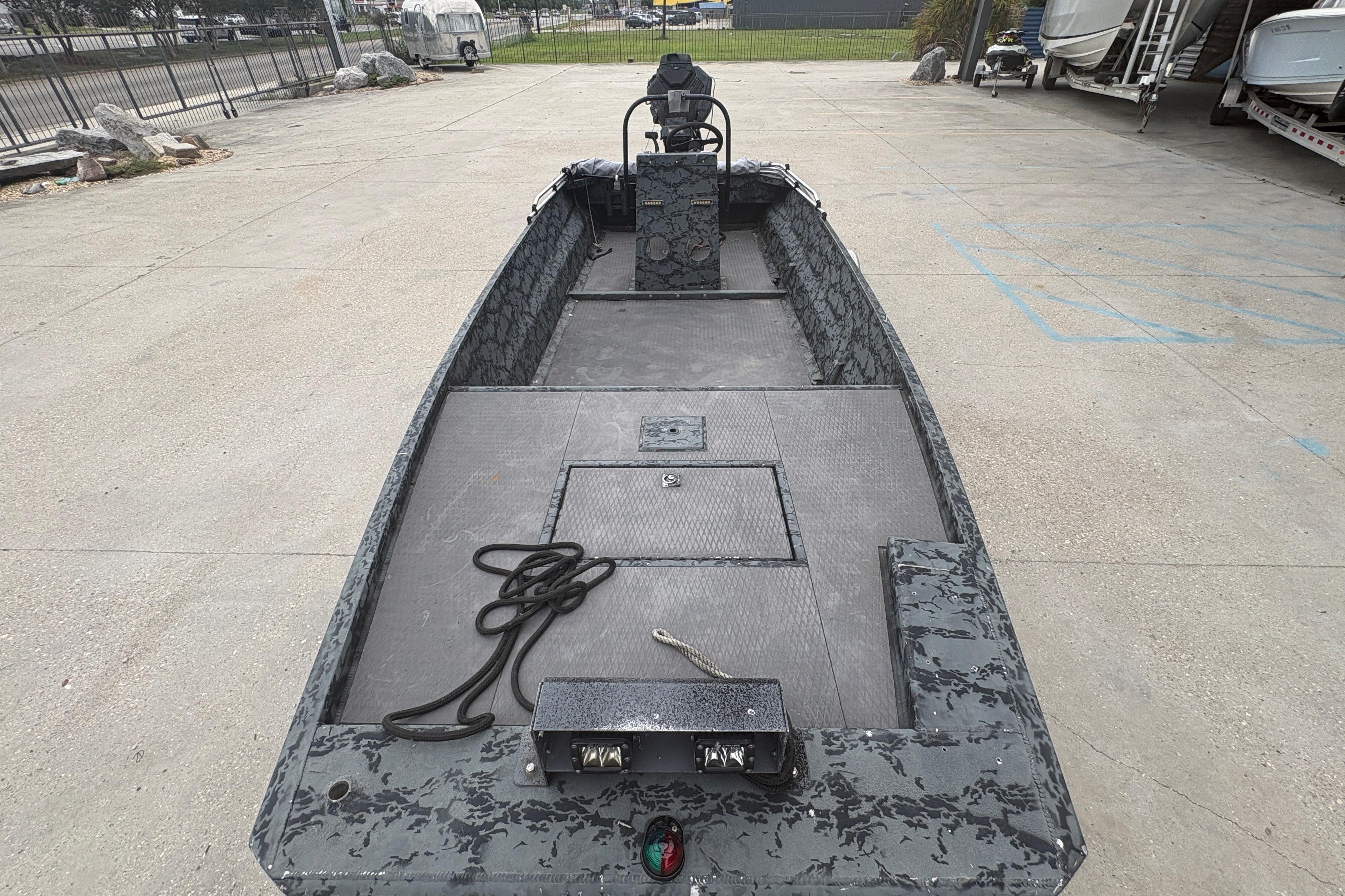 2020 Gator Tail Extreme boat with camouflage design, parked on concrete surface.