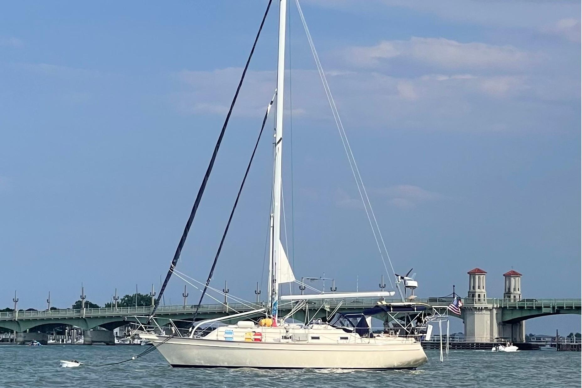 Sailboat Island Packet 380, 2001 model, anchored near a bridge on a sunny day.