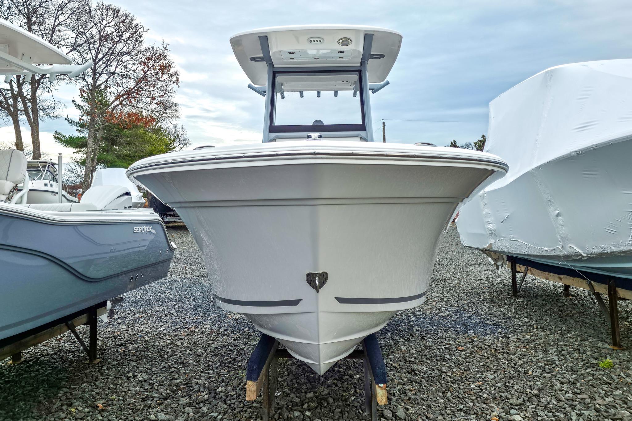2026 Sea Fox 228 Commander boat displayed outdoors on gravel lot.