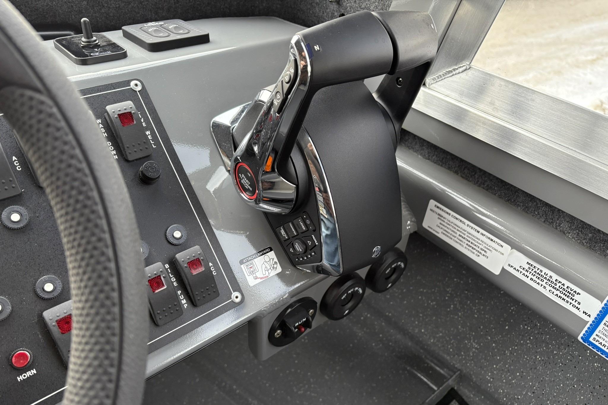 Control panel of 2024 Spartan 26 Maximus Pro XL boat with throttle and switches.