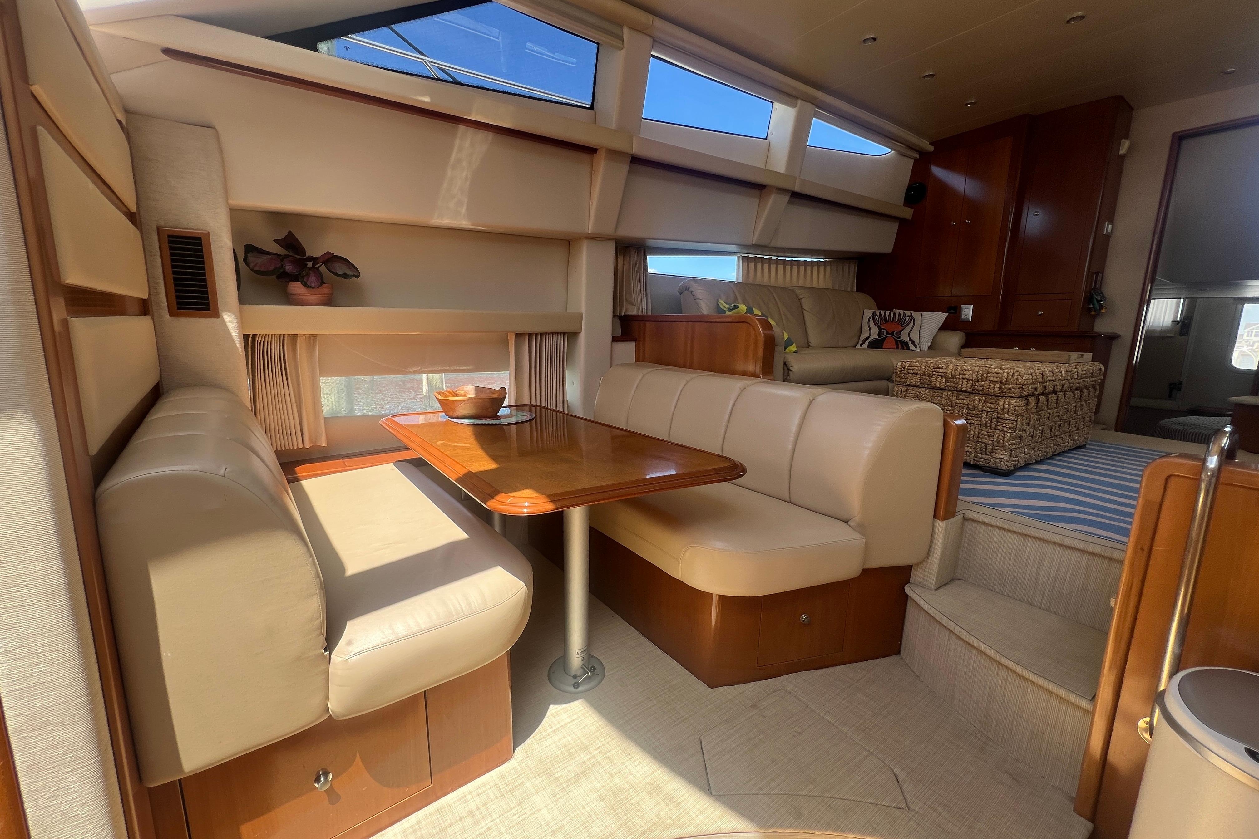 Luxurious interior of a 2006 Carver 43 Motor Yacht with elegant seating and dining area.
