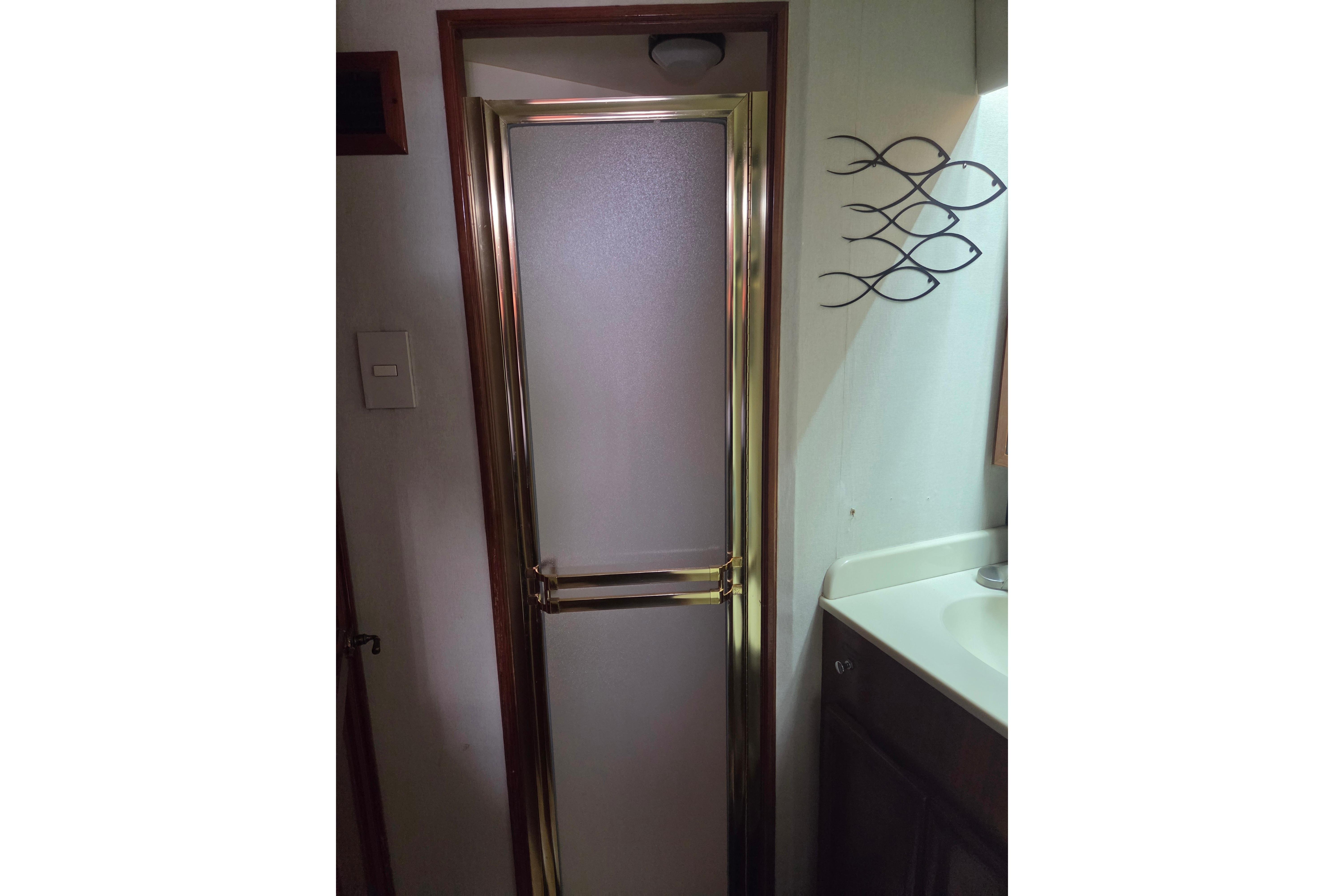 Shower door in 1990 Egg Harbor Golden Egg 42 yacht bathroom.