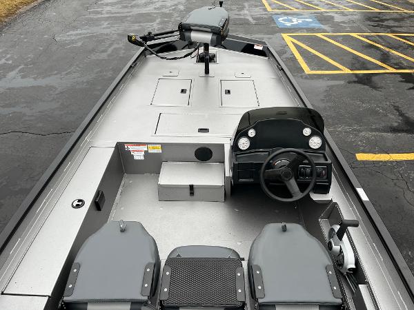2024 Lowe Legacy boat interior with steering console and seating.