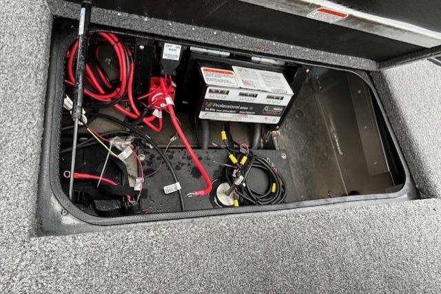 Battery compartment of 2025 Ranger ALPHA 208 with wiring and cables.