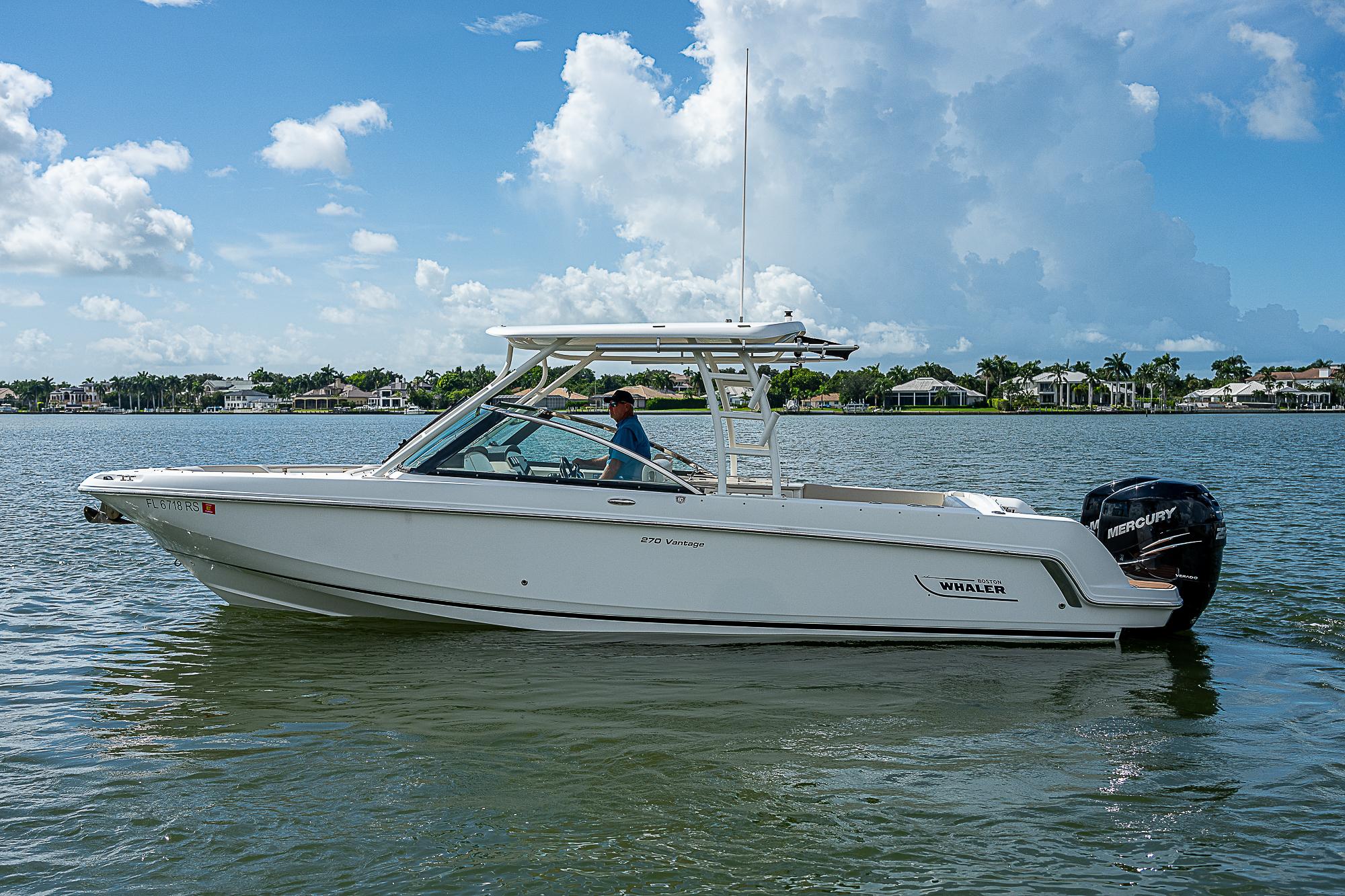 2018 Boston Whaler 270 Vantage boat on calm water, clear sky background.