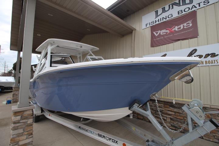 2026 Sea Fox 268 Traveler boat on trailer outside a fishing boat dealership.
