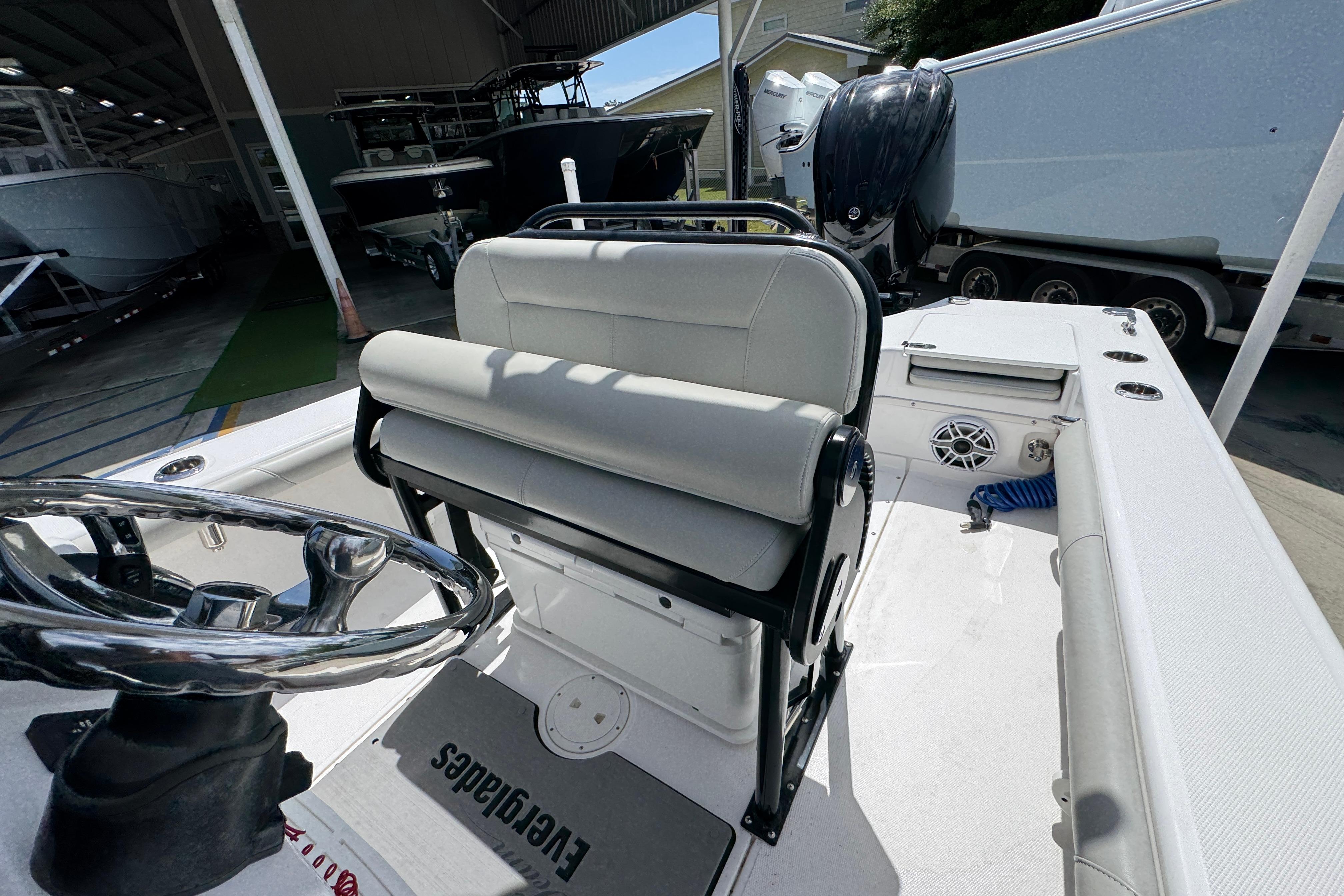2022 Everglades 243 Center Console boat interior with steering wheel and seating.