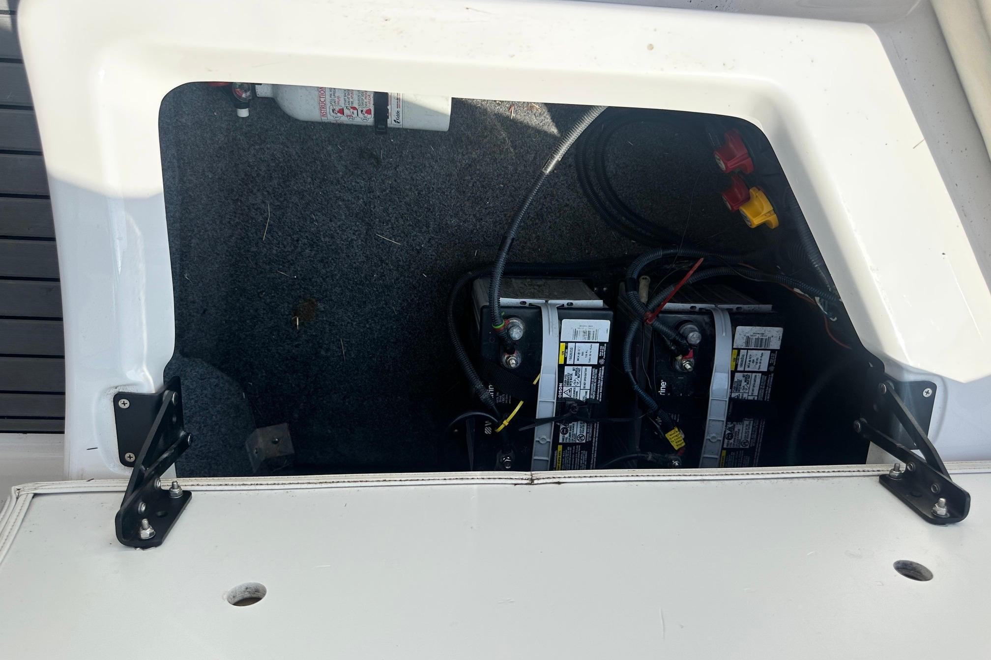 Battery compartment of a 2016 Yamaha 242 Limited S boat, showing dual batteries and wiring.