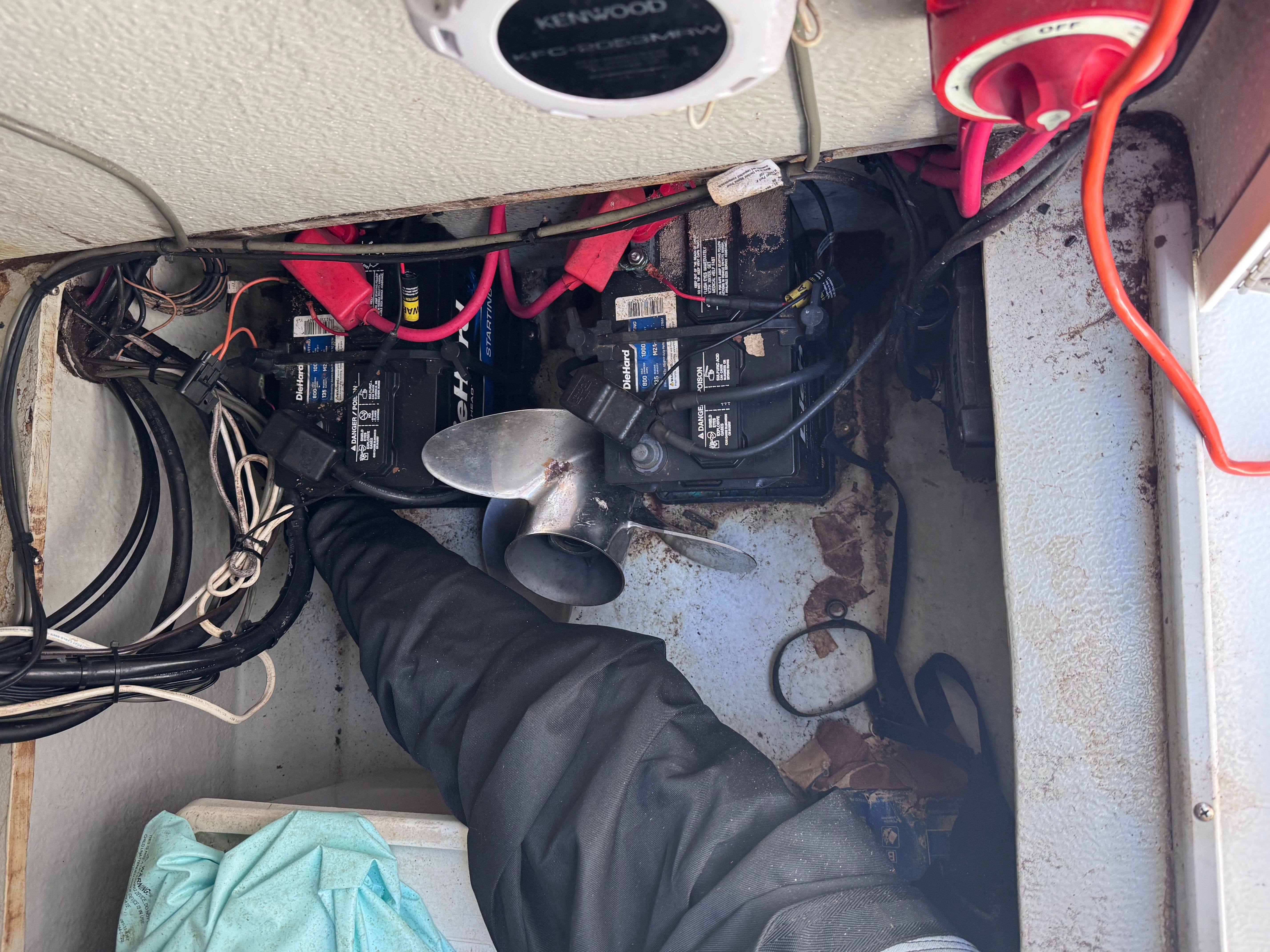 Interior of a Dusky 20.3 boat with batteries and cables.