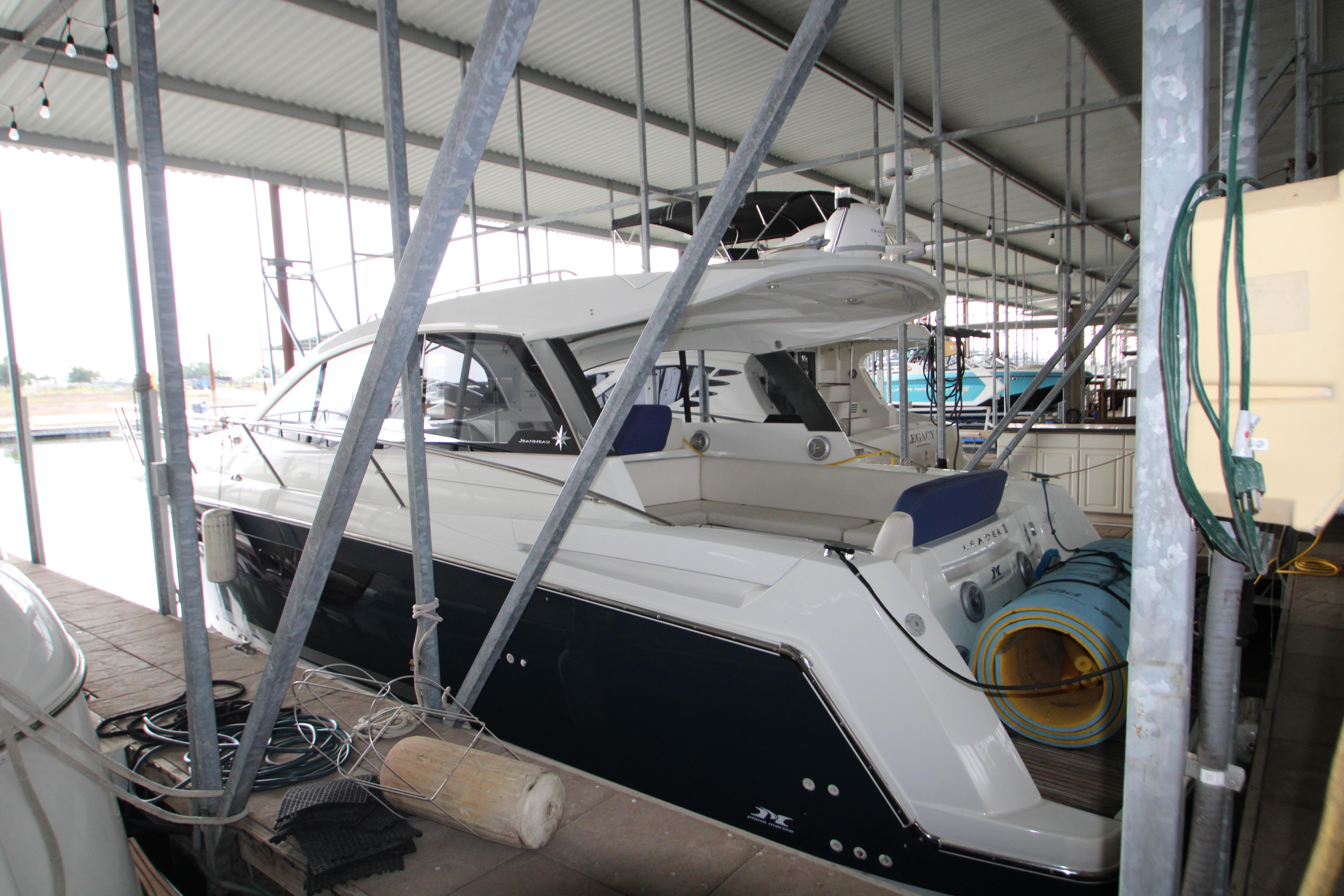 2012 Jeanneau Leader 10 yacht docked in a covered marina.