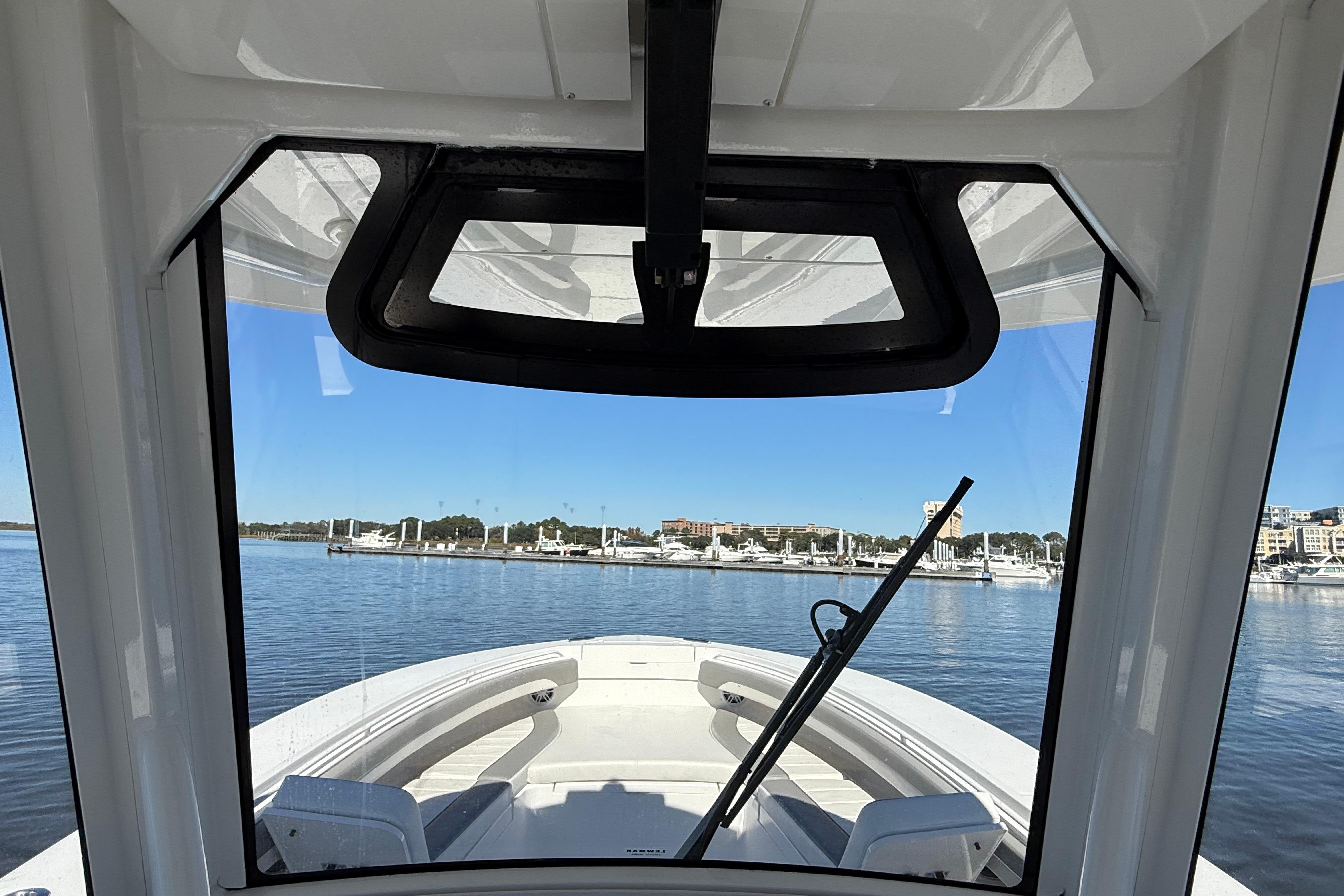 2022 Regulator 34 boat interior view through windshield at marina.