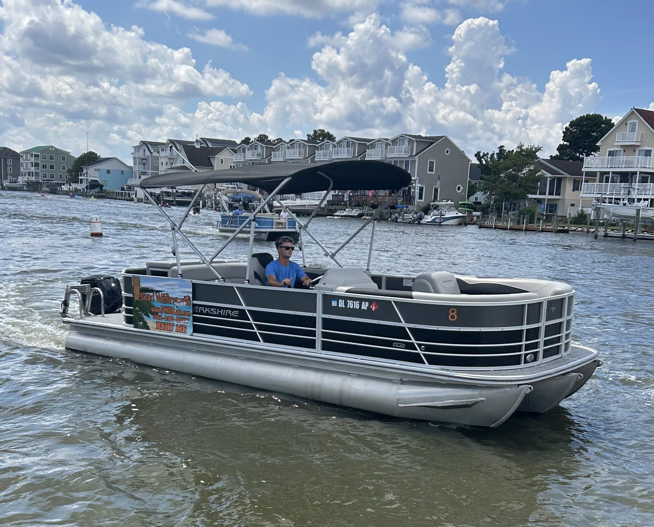 2024 Berkshire 24CL LE 2.75 pontoon boat cruising on a sunny day.