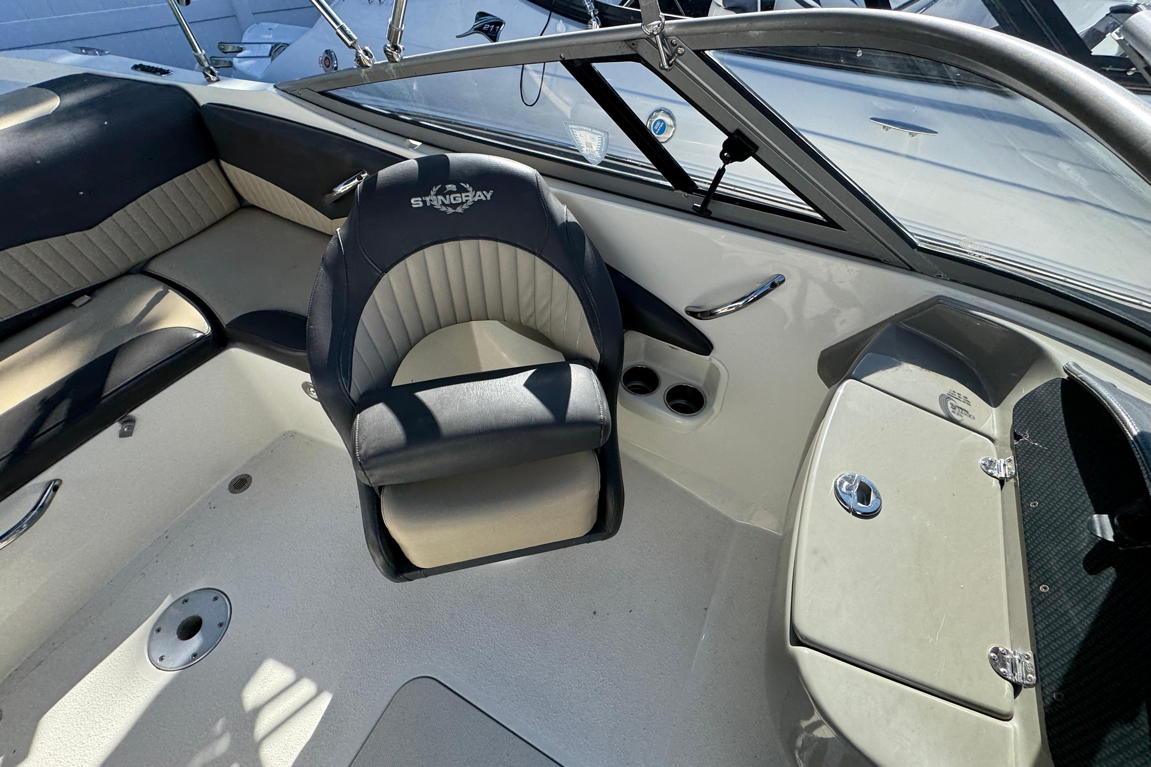 Interior of a 2018 Stingray 204 LR boat with seating and dashboard.