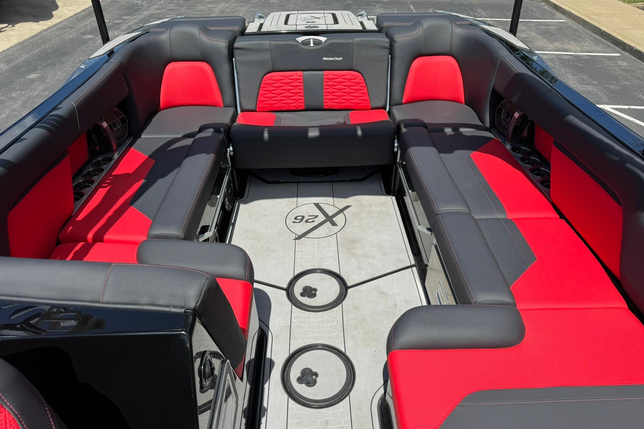 Interior of a 2021 MasterCraft X26 boat with red and black seating.