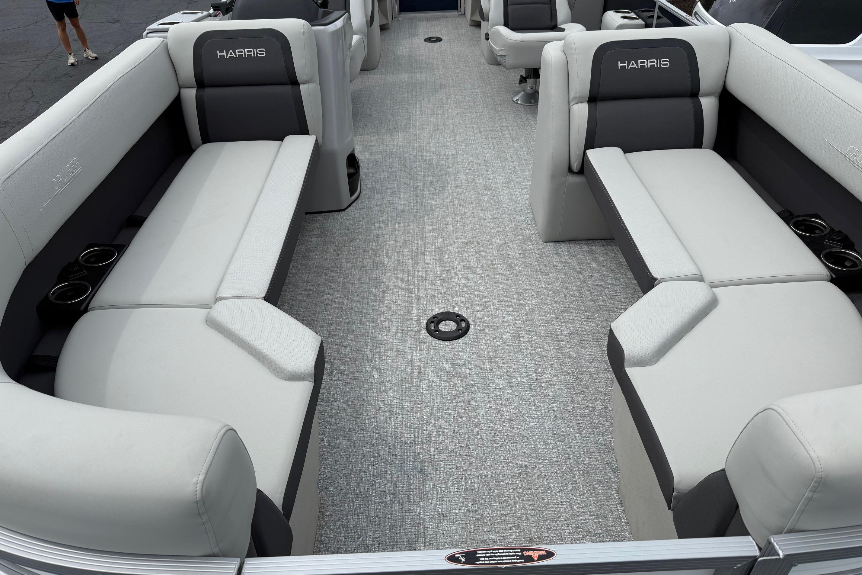 2025 Harris Cruiser 230 interior with gray seating and cup holders.
