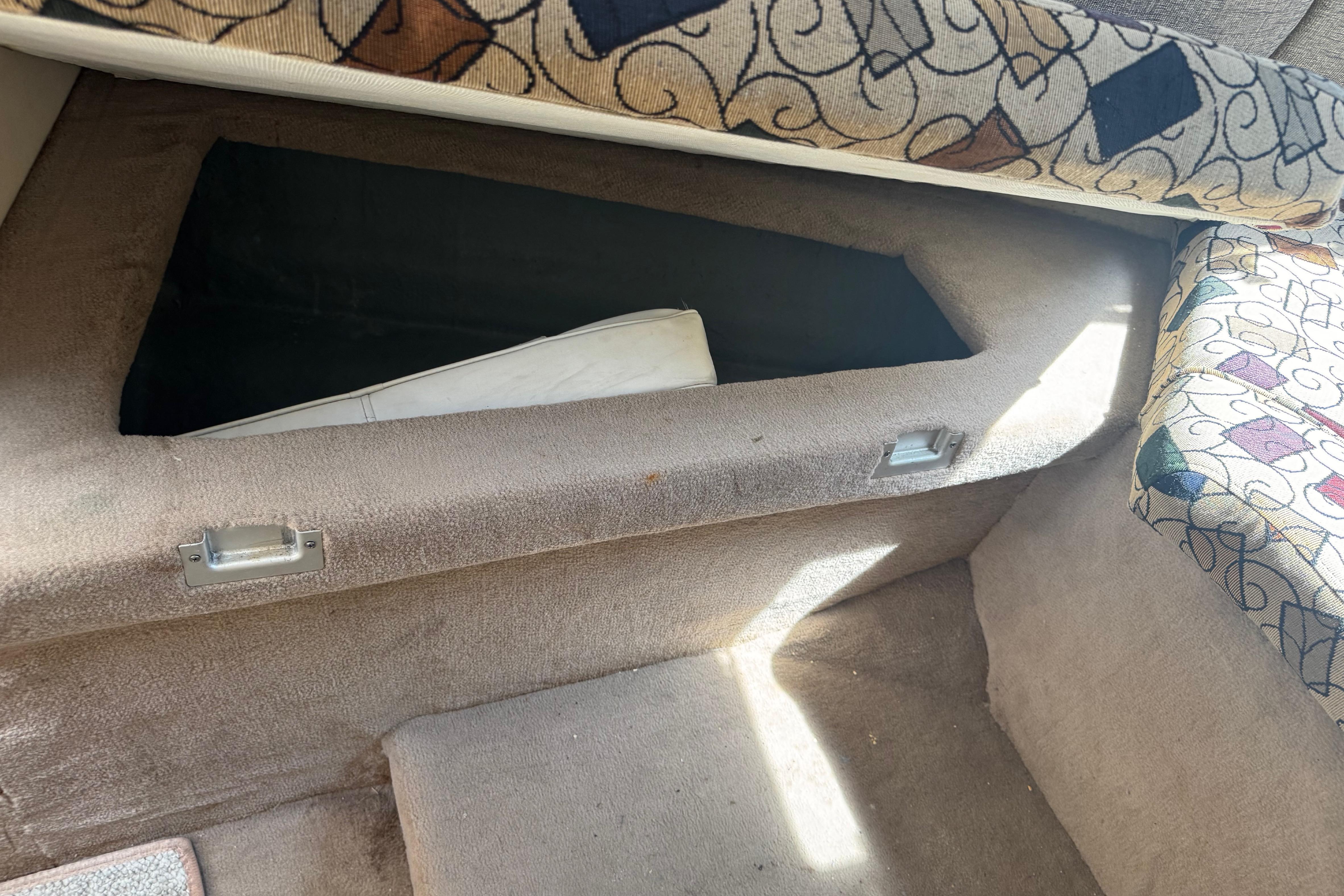 Interior storage compartment of a 2001 Sea Ray 245 Weekender boat.