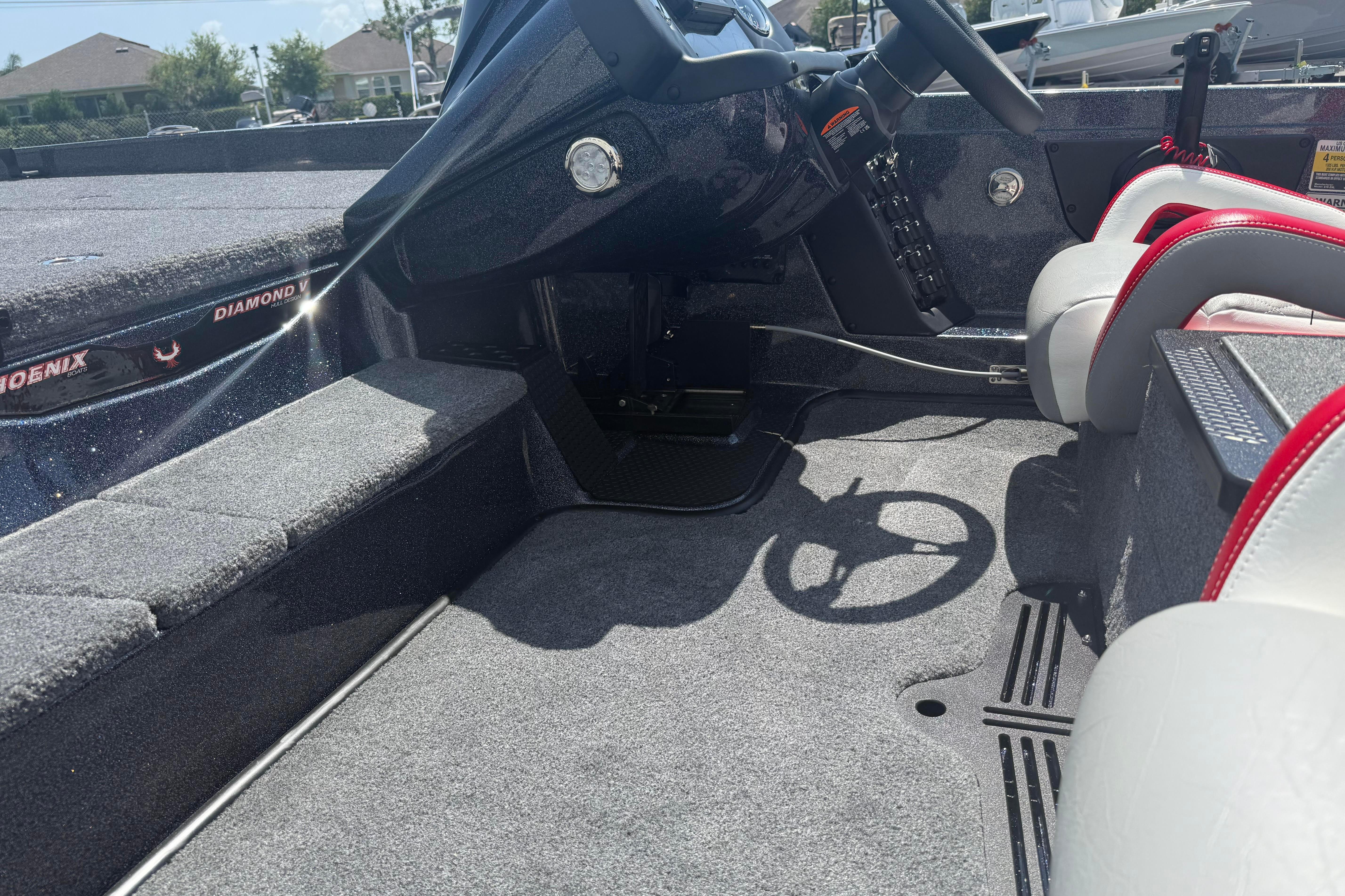 Interior of a 2027 Phoenix 819 ZXL boat with steering wheel and seating.