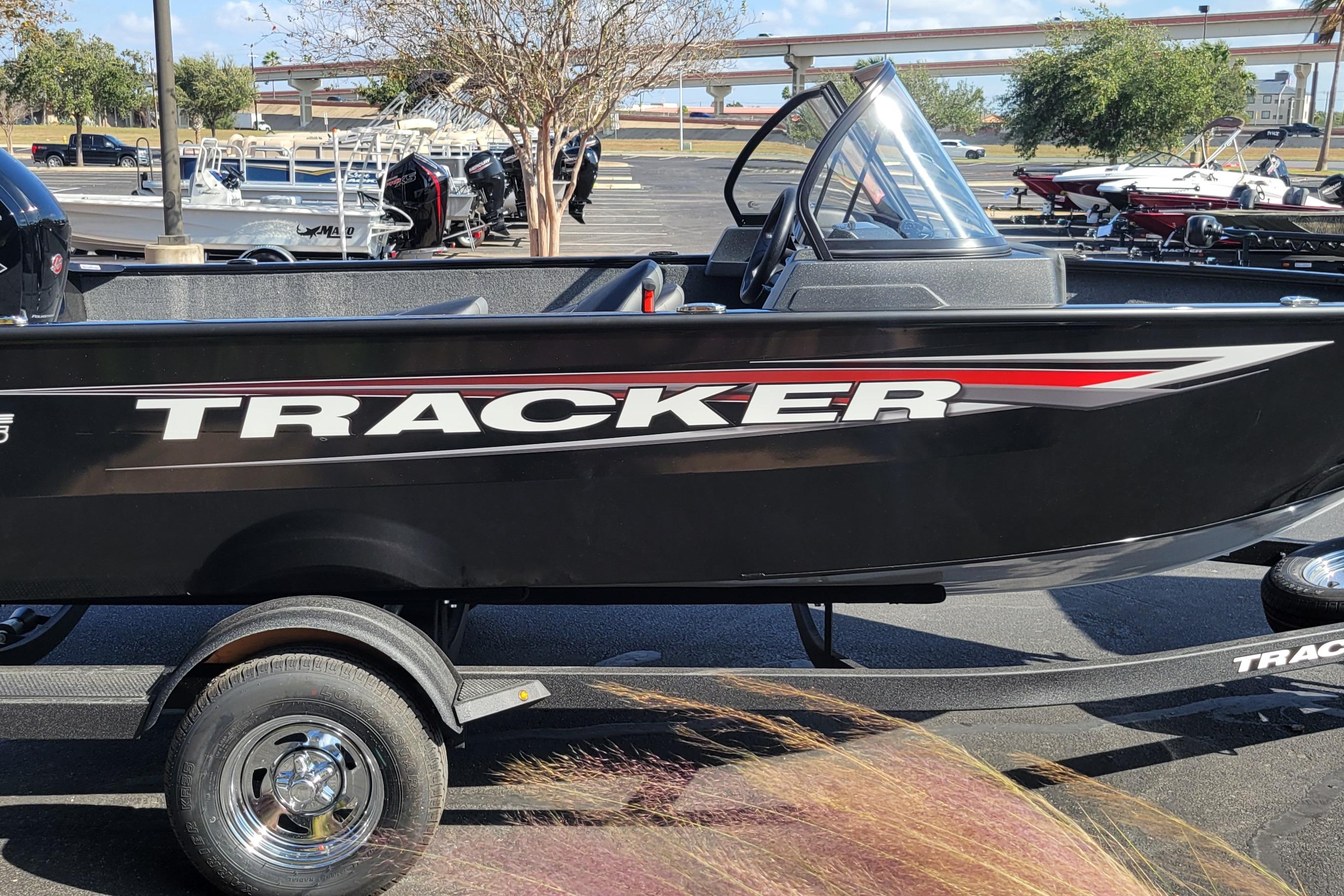 2026 Tracker Pro Guide V-175 Combo boat on trailer in parking lot.