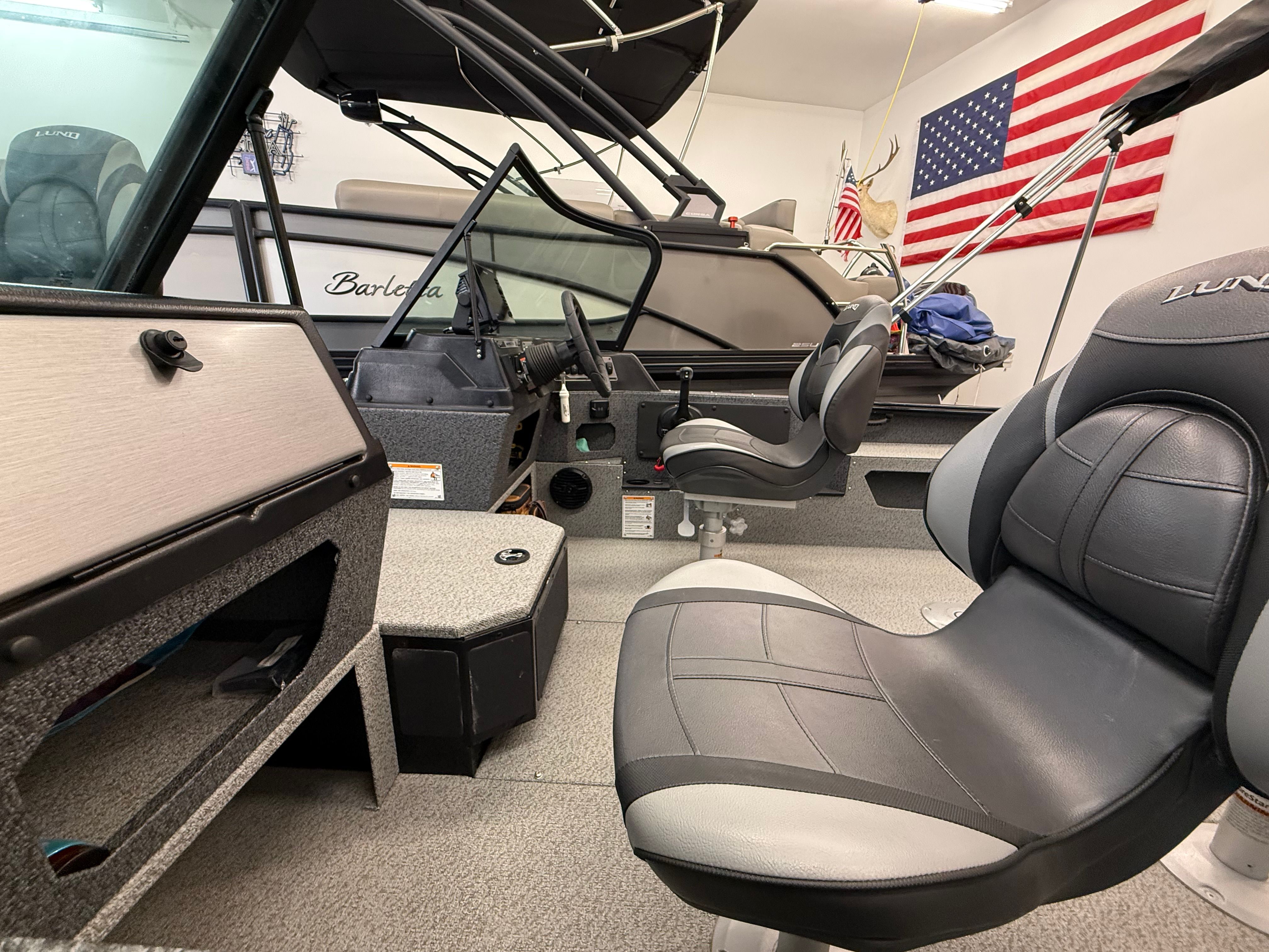 Interior view of a Lund 1875 Impact XS Sport boat with seating and control console.