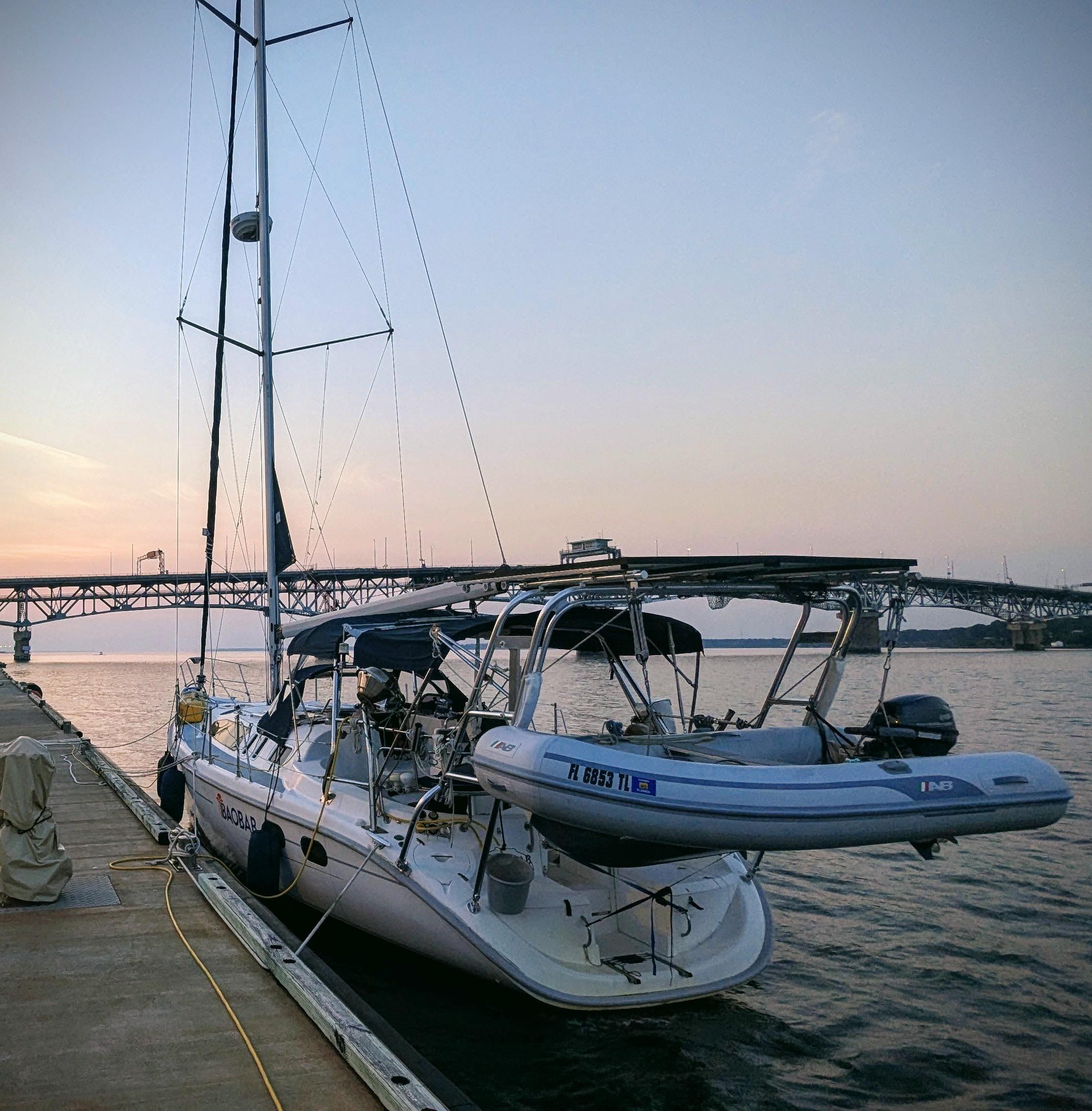 Sailboat docked at sunset, Hunter 380, 2001 model, near a bridge.
