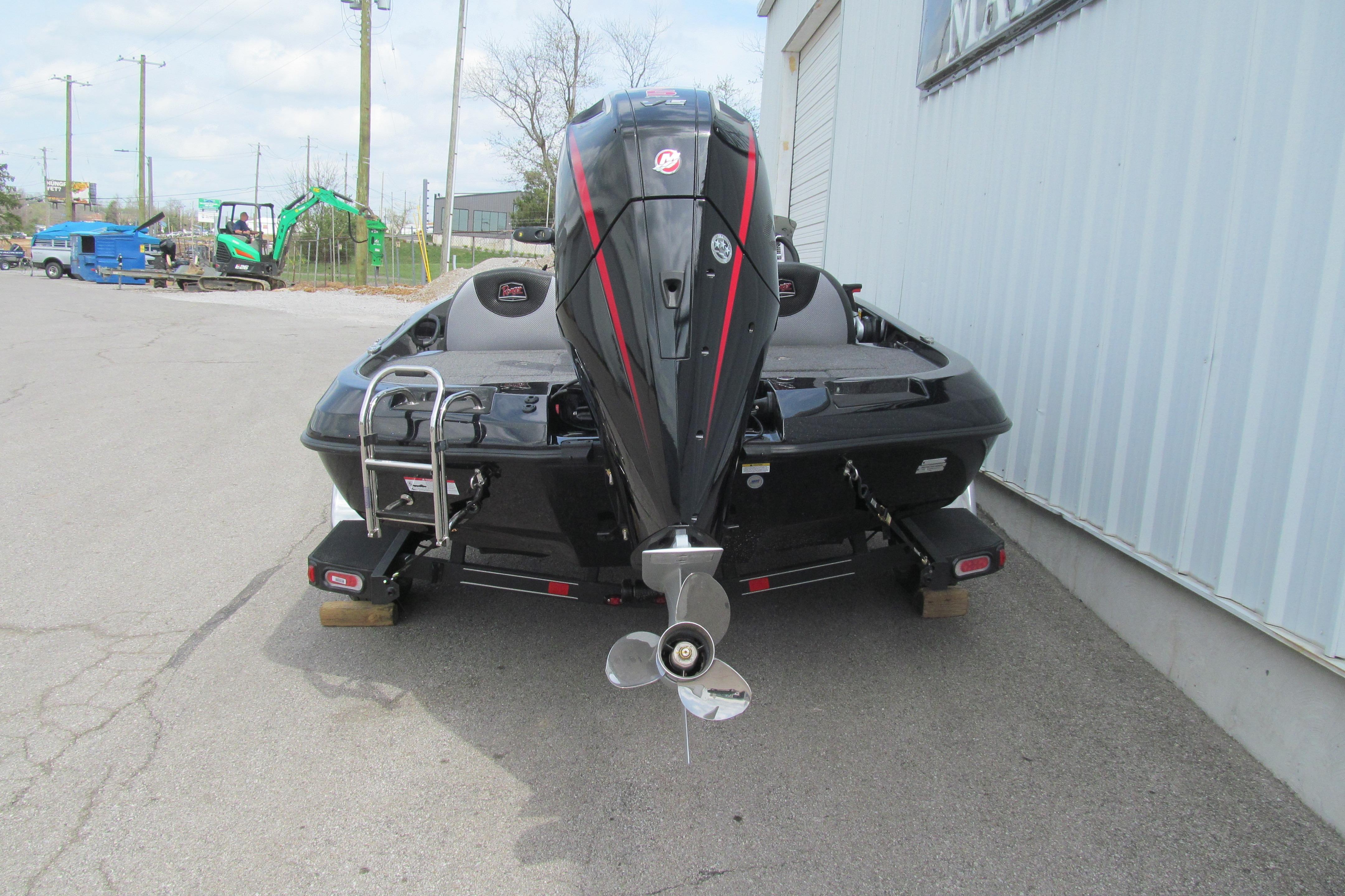 2026 Ranger Z185 boat with outboard motor, parked on pavement near a building.