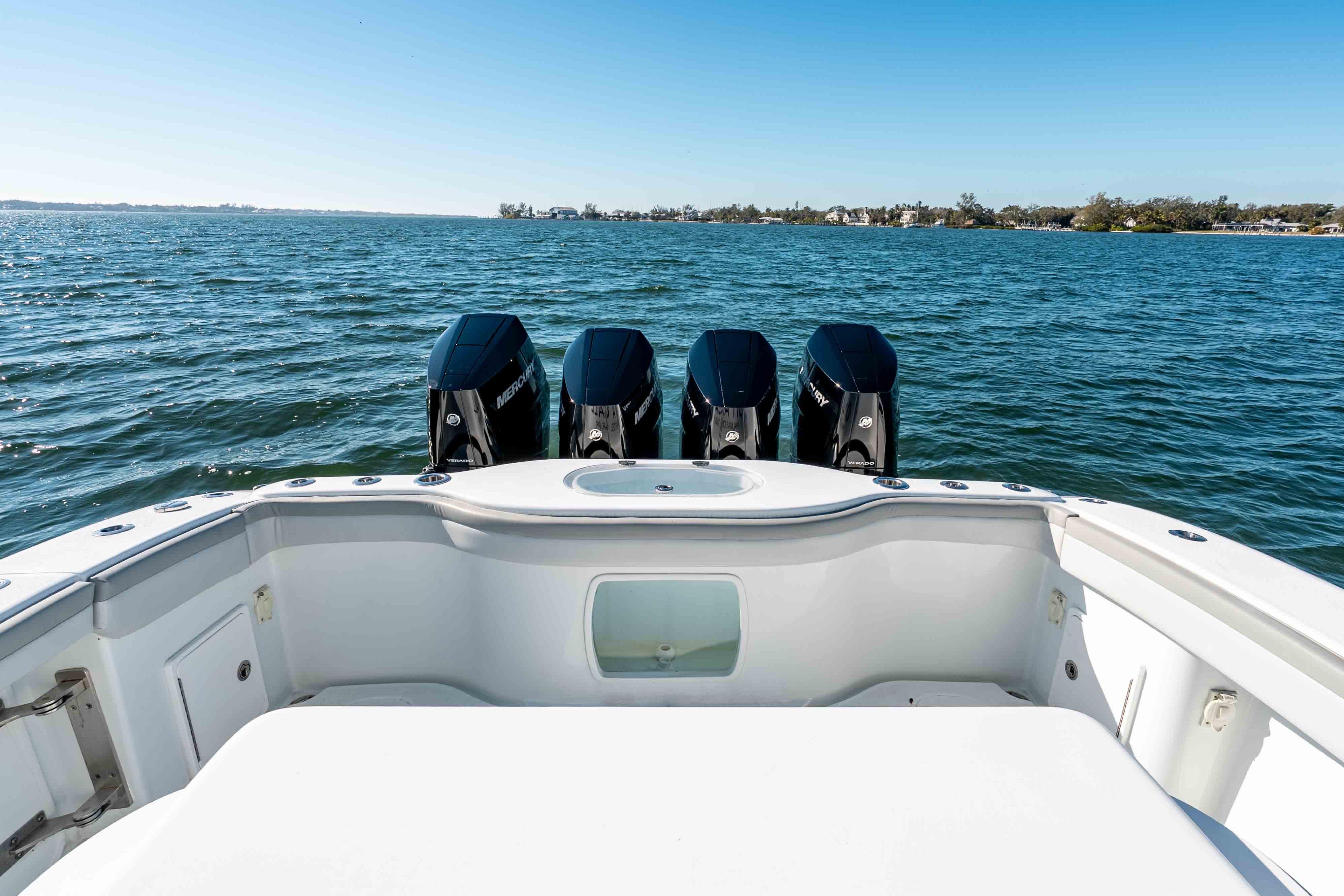 2023 Yellowfin 42 Offshore boat with four powerful outboard engines on open water.