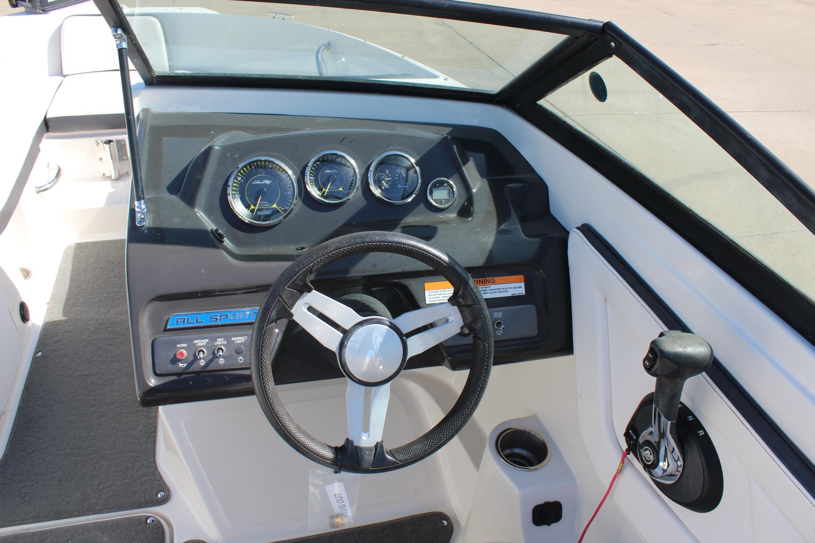 2015 Sea Ray 19 SPX OB boat dashboard with steering wheel and control panel.