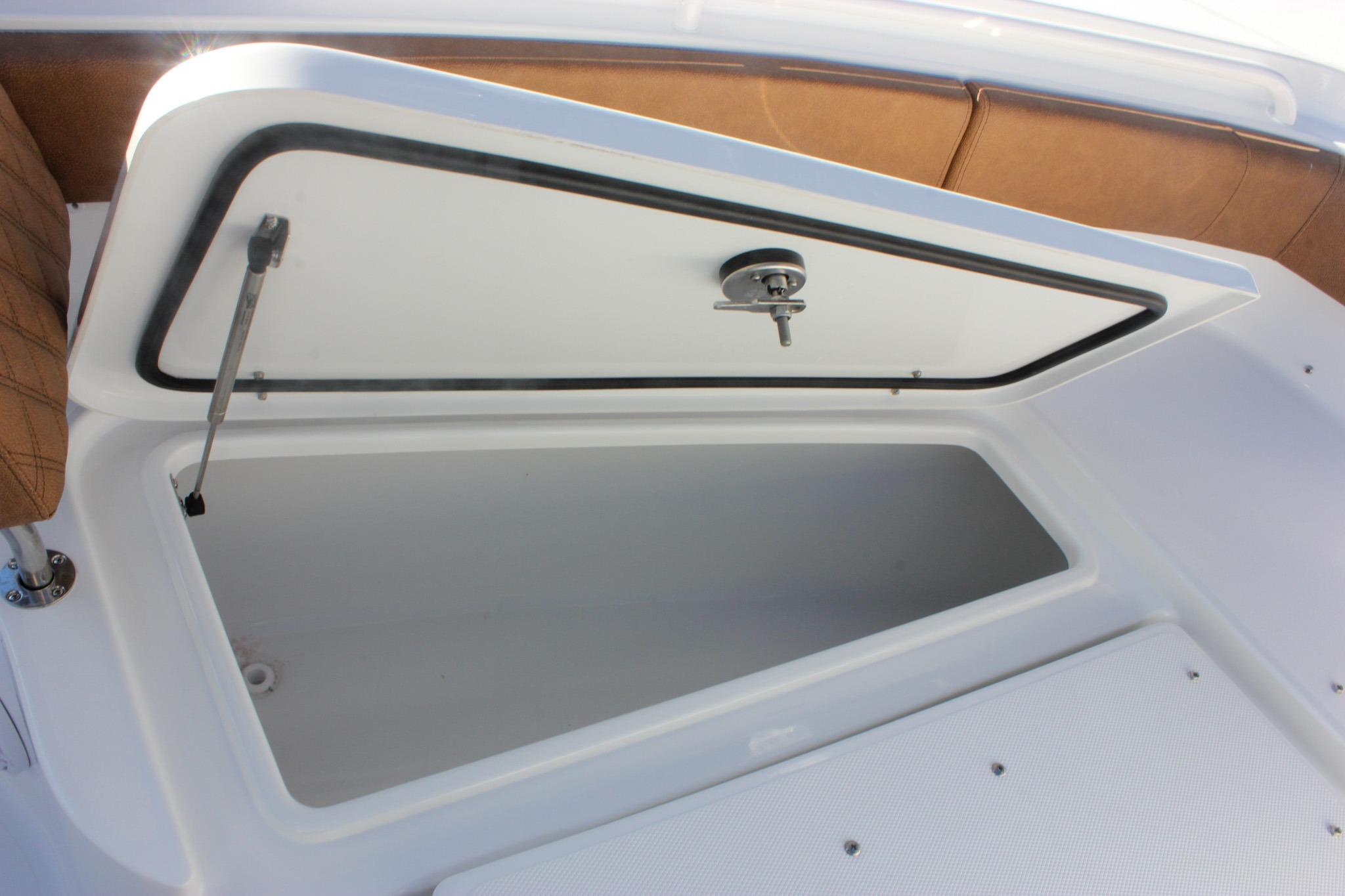 Open storage compartment on 2026 Sea Hunt Ultra 285 SE boat.
