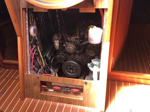 Engine compartment of a 2001 Jeanneau 45.2 sailboat, showcasing mechanical components and wiring.