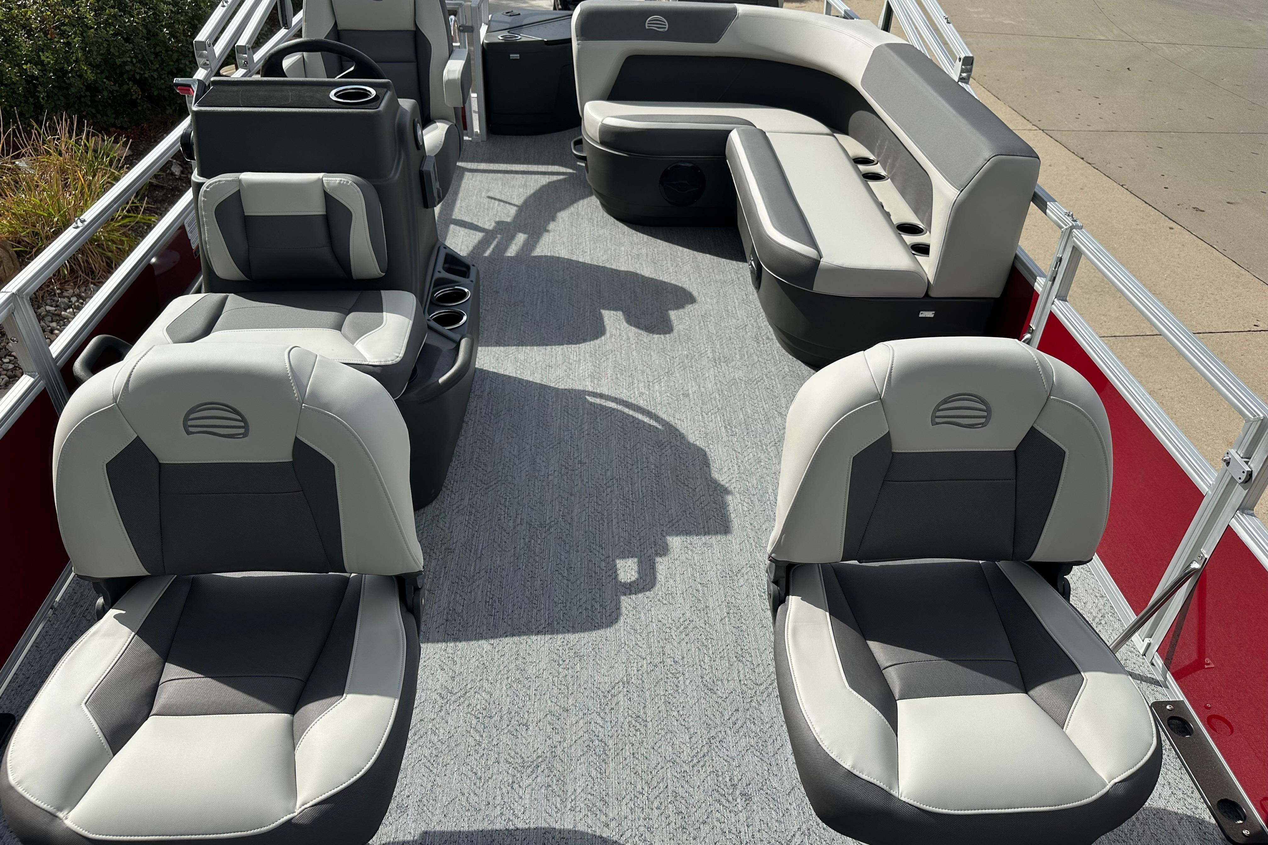 2026 Sun Tracker Bass Buggy 18 DLX pontoon boat interior with gray seating and carpet.