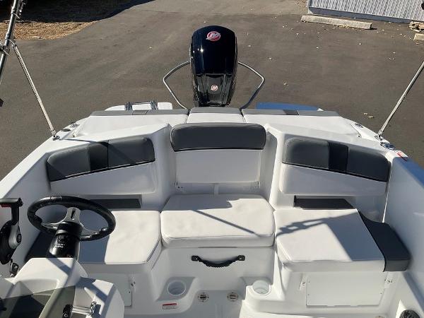 2025 Tahoe T18 boat interior with seating and steering wheel, showcasing modern design.