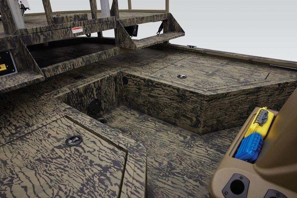 2026 Tracker GRIZZLY® 2072 CC Sportsman boat interior with camo design and storage compartments.
