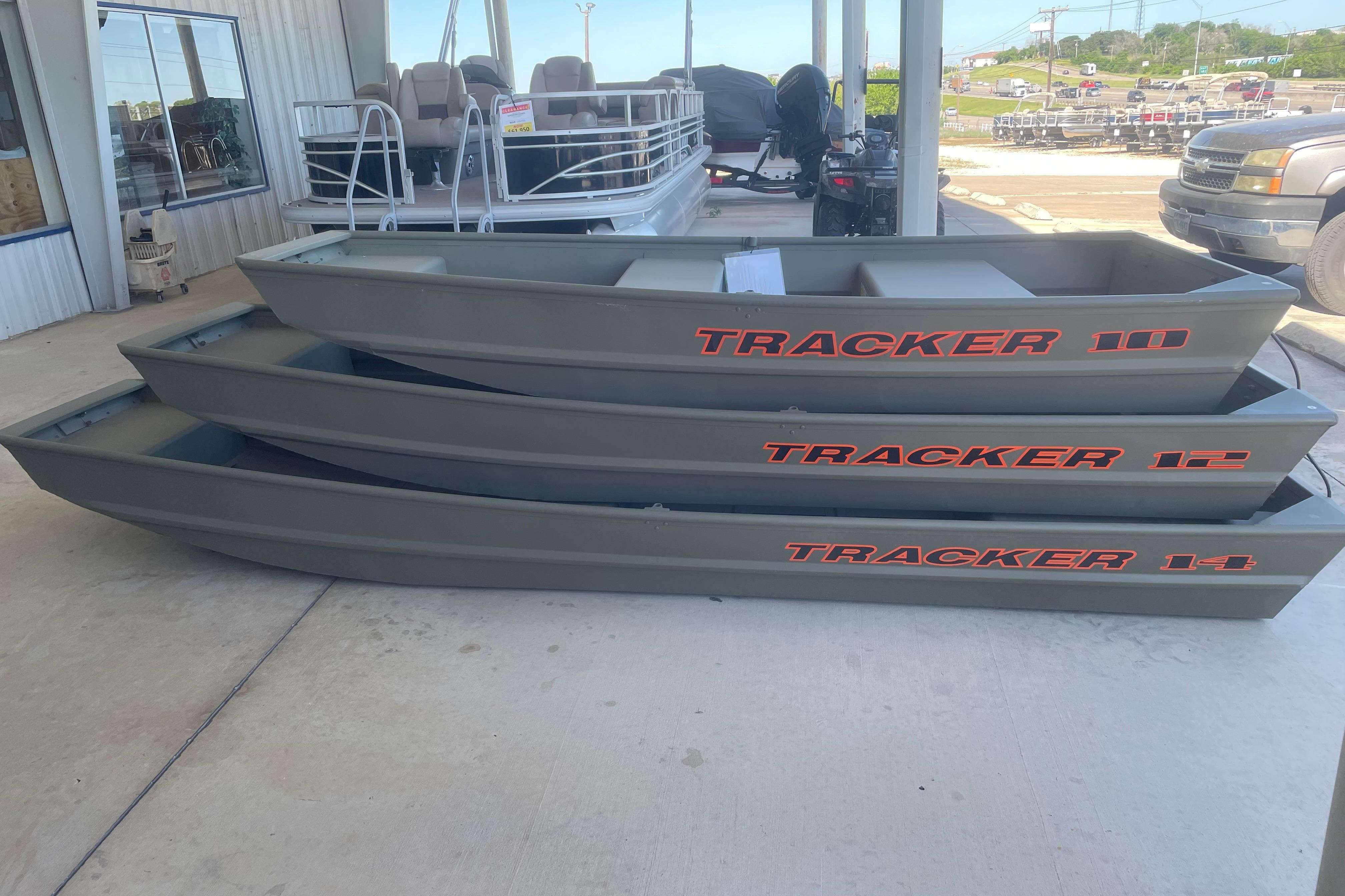 Stacked 2026 Tracker Grizzly 10 Jon boats displayed at a dealership.