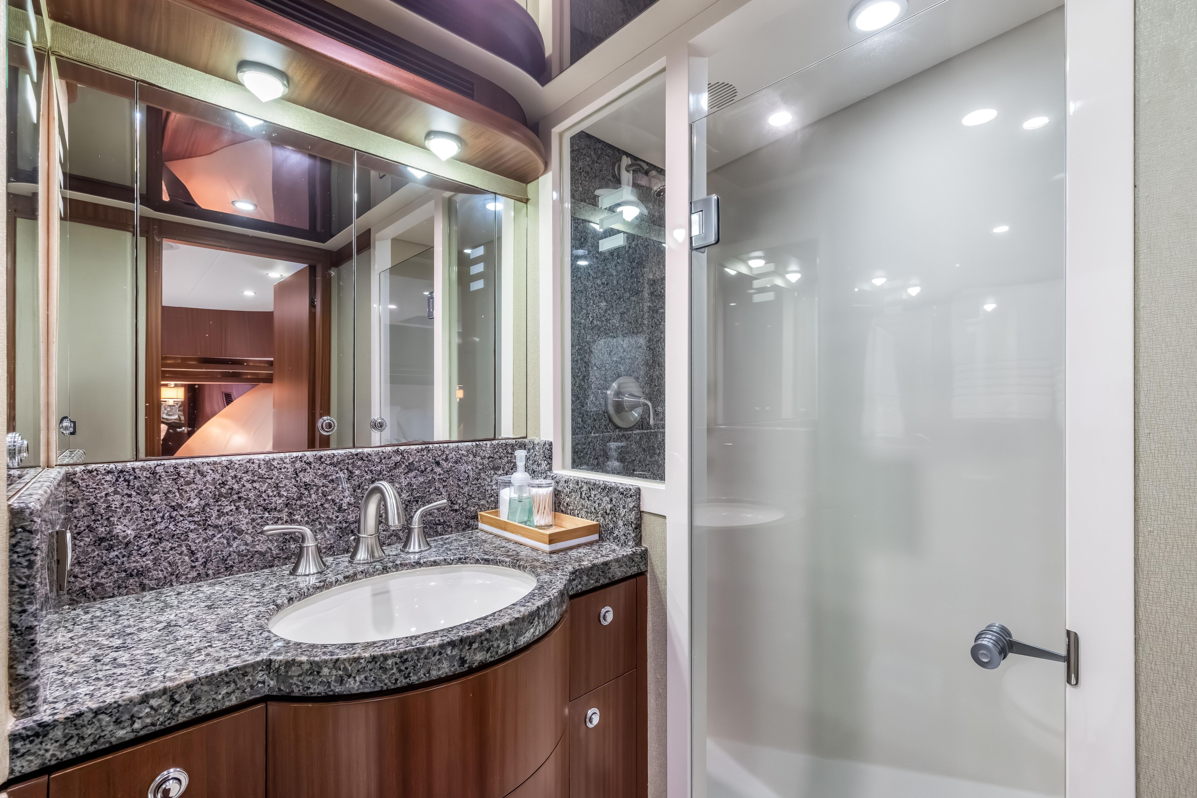 Luxurious bathroom in 2012 Cheoy Lee 84 Bravo yacht with granite countertop and modern fixtures.