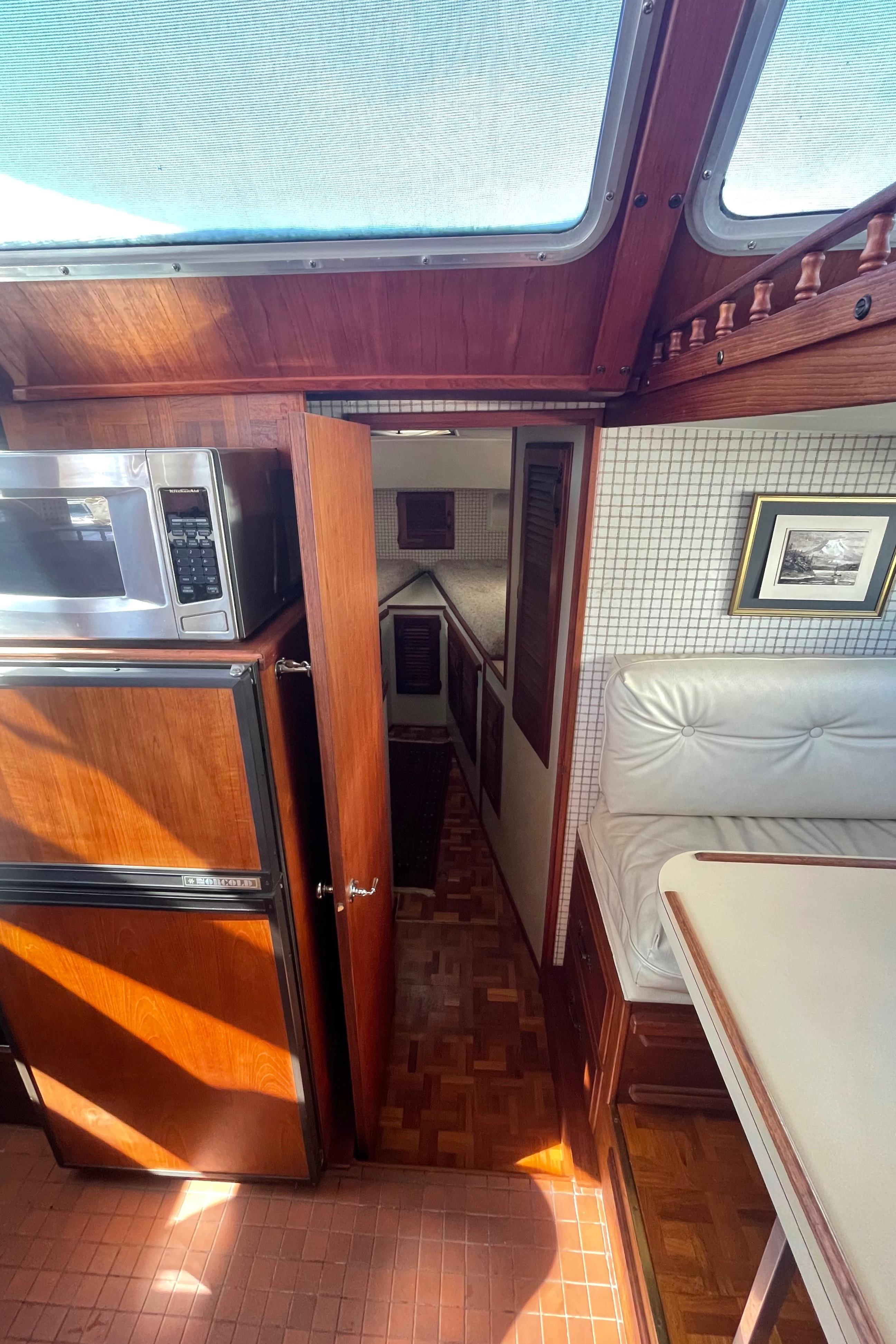 Interior of 1981 Tollycraft 48 Motor Yacht with wood finishes and natural light.